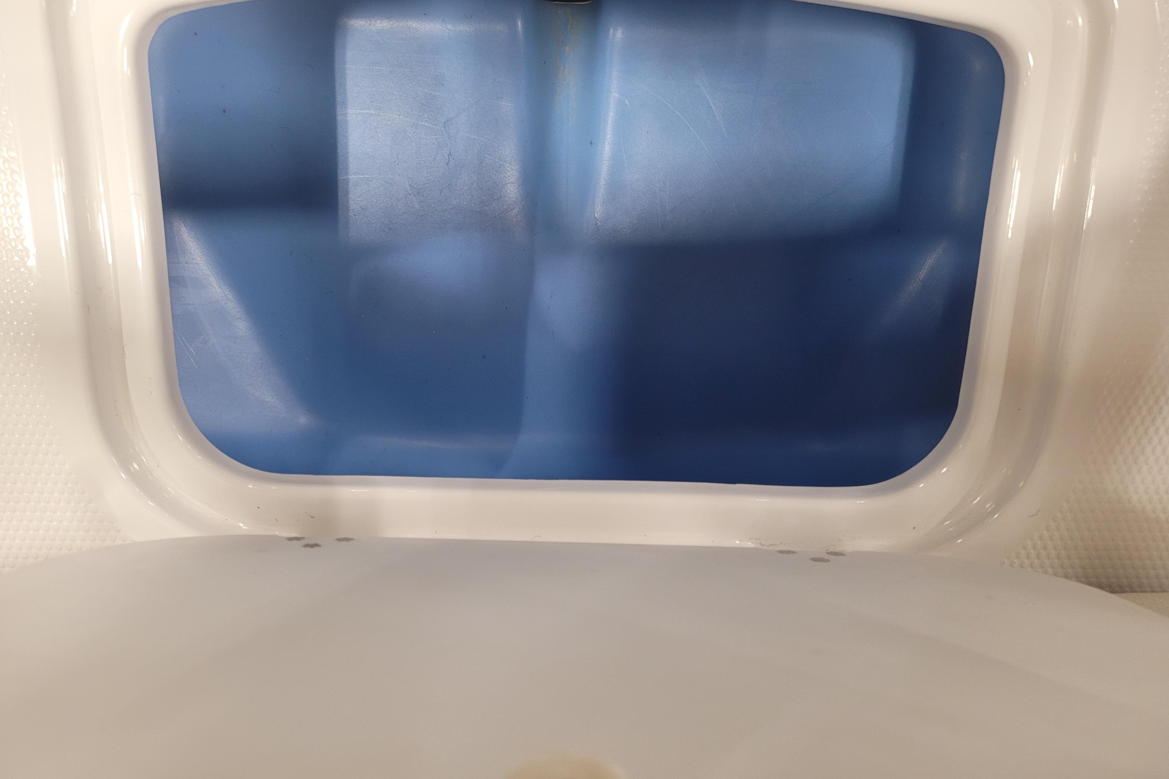Storage compartment of a 2026 Tahoe 2150 boat, featuring a blue interior.