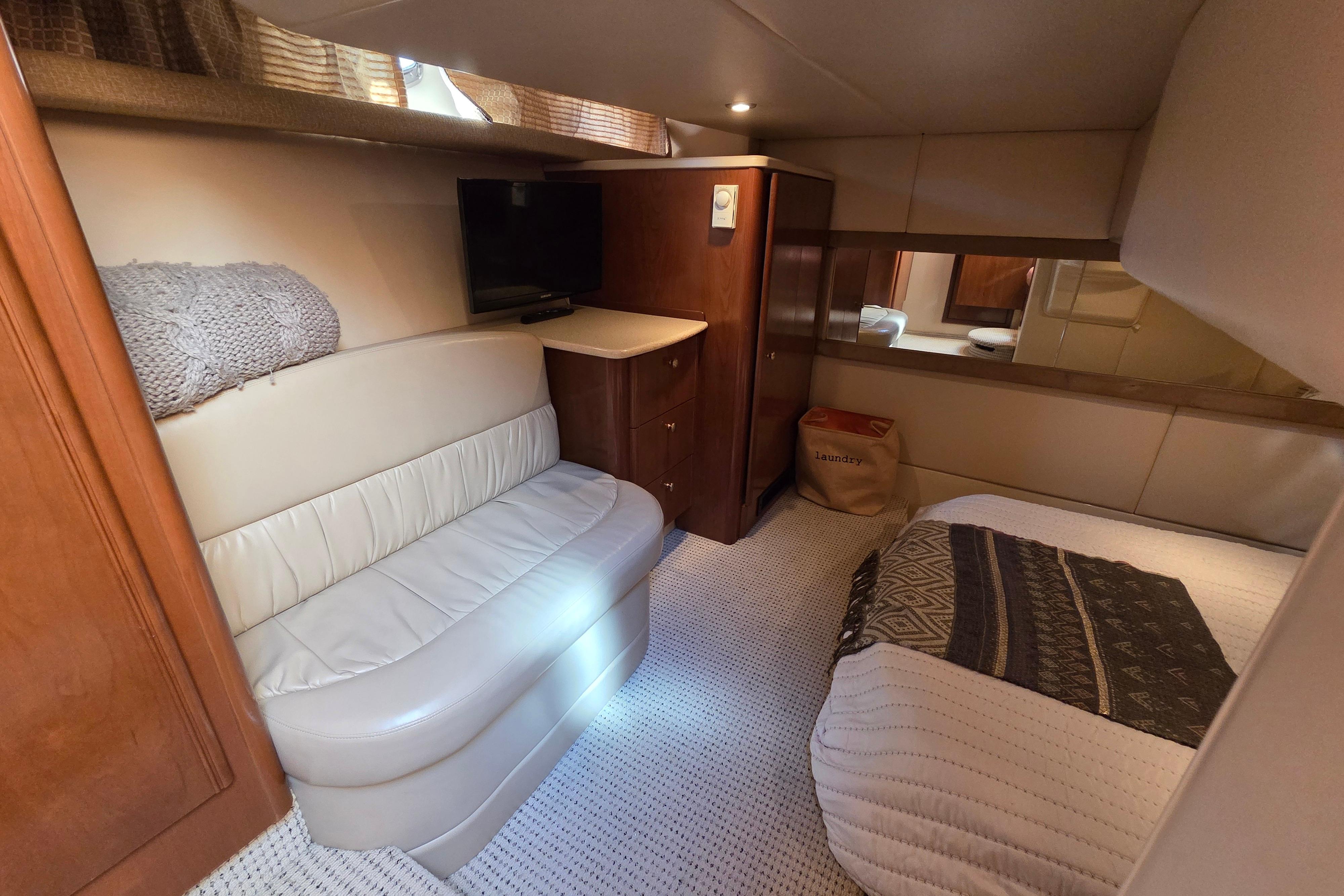 Luxurious interior of 2005 Meridian 411 Sedan yacht with cozy seating and elegant decor.