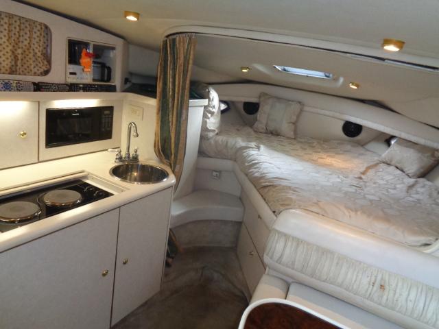 1997 Regal 292 Commodore interior with kitchenette and cozy sleeping area.