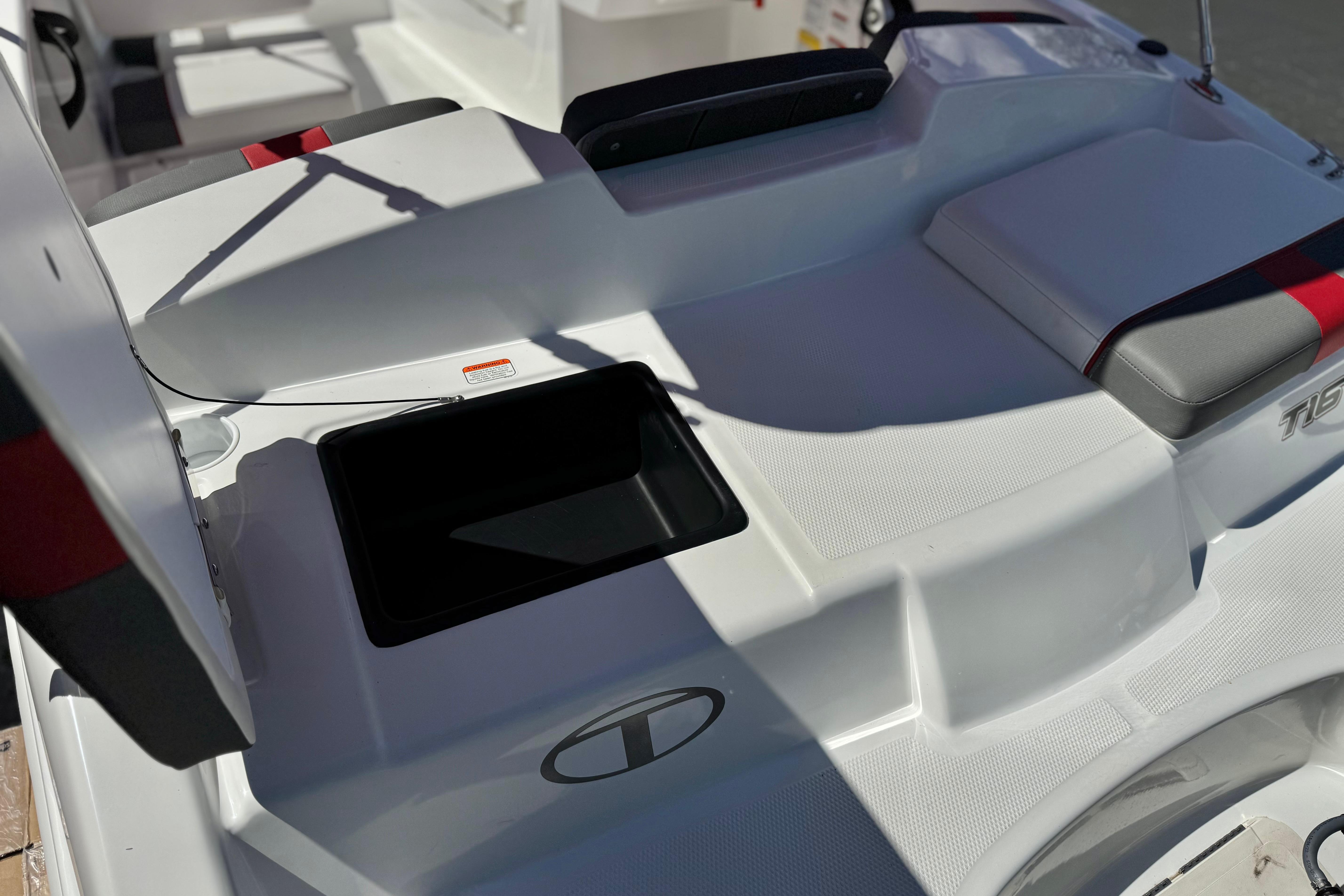2024 Tahoe T16 boat interior with open storage compartment and cushioned seating.
