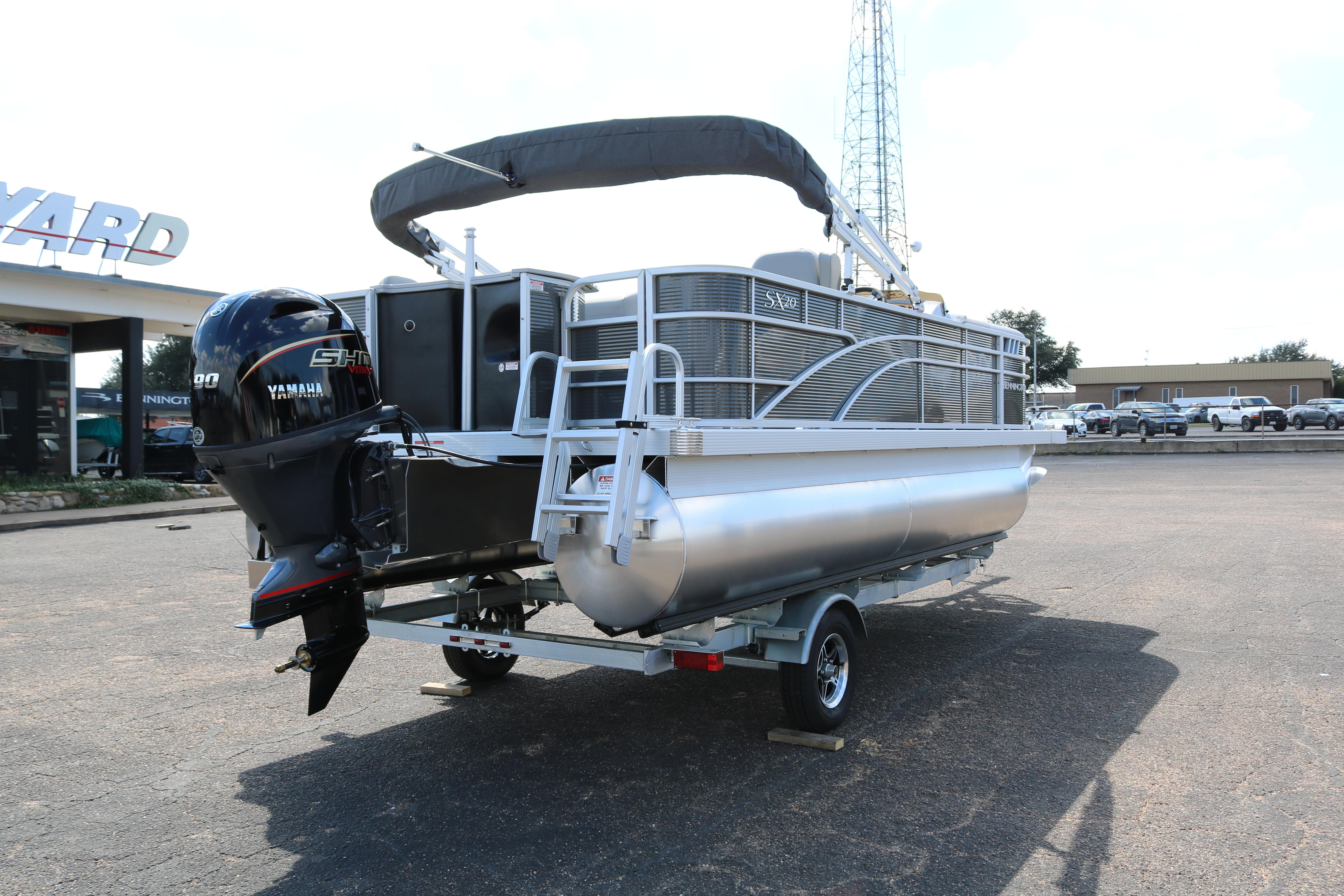 2026 Bennington 20SXSNP REAR FISH pontoon boat with Yamaha engine on trailer.