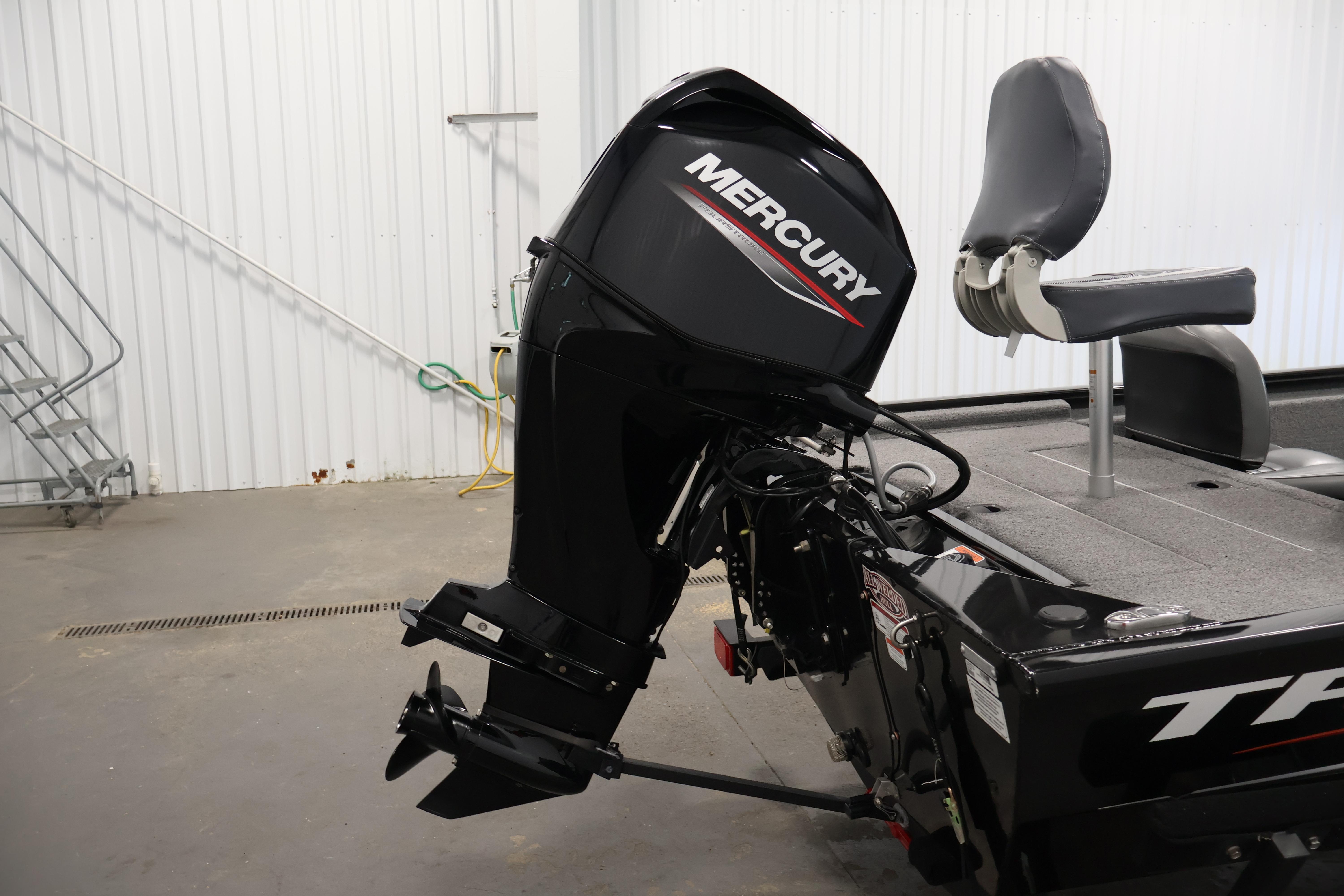2024 Tracker Pro 170 boat with Mercury outboard motor in a garage setting.