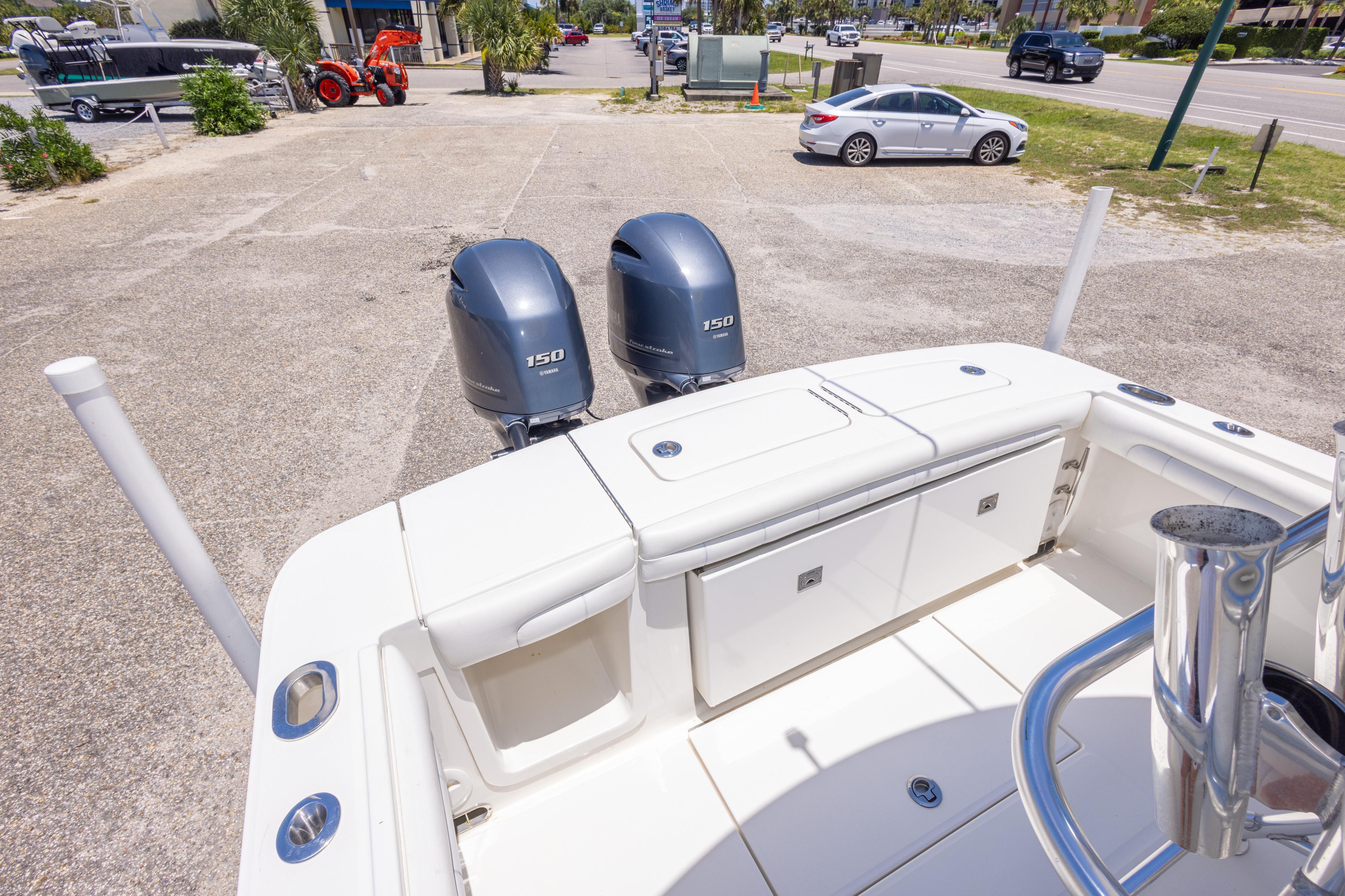 2019 Regulator 23 Center Console boat with dual 150 horsepower engines, parked outdoors.