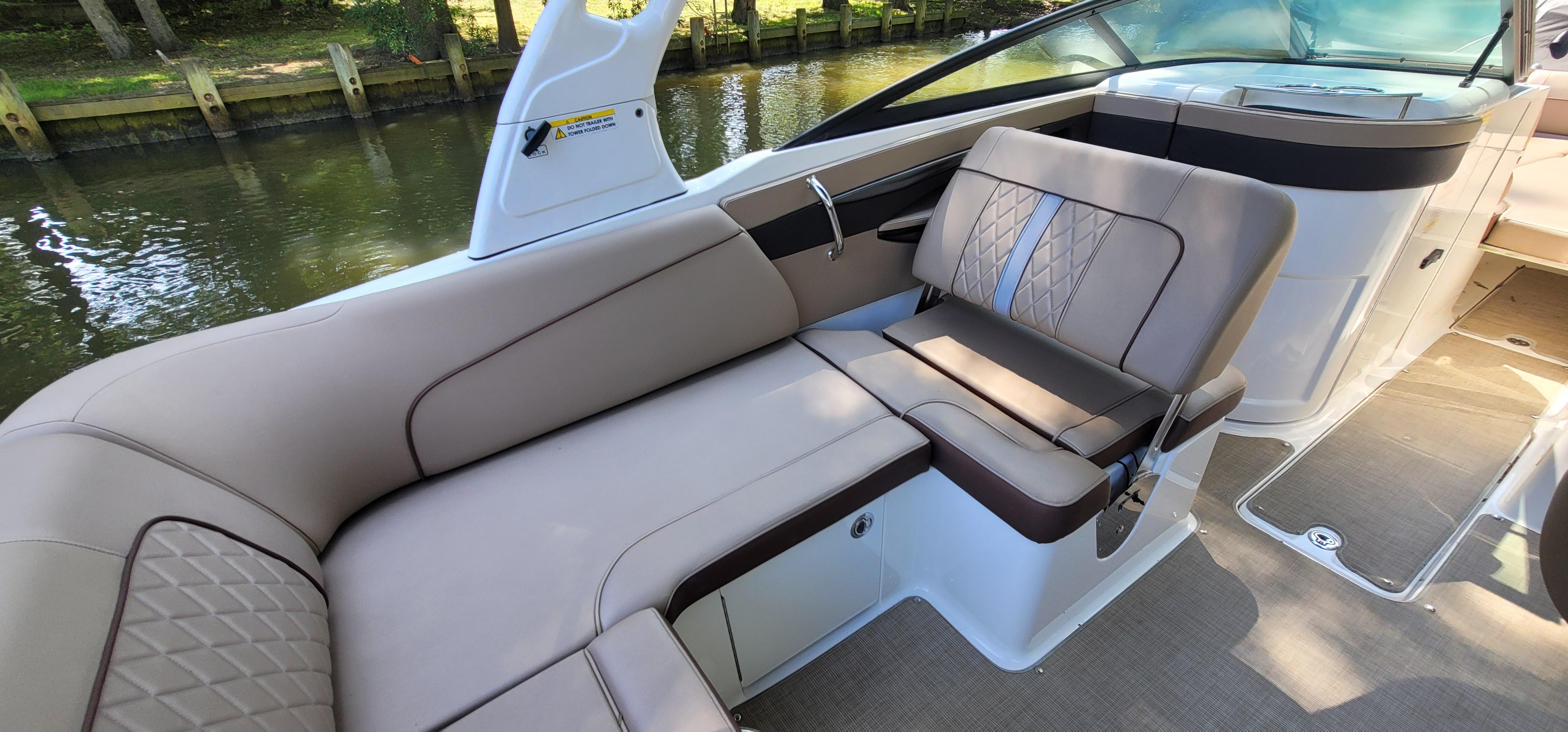 2017 Sea Ray SDX 240 Outboard boat interior with luxurious seating by the water.