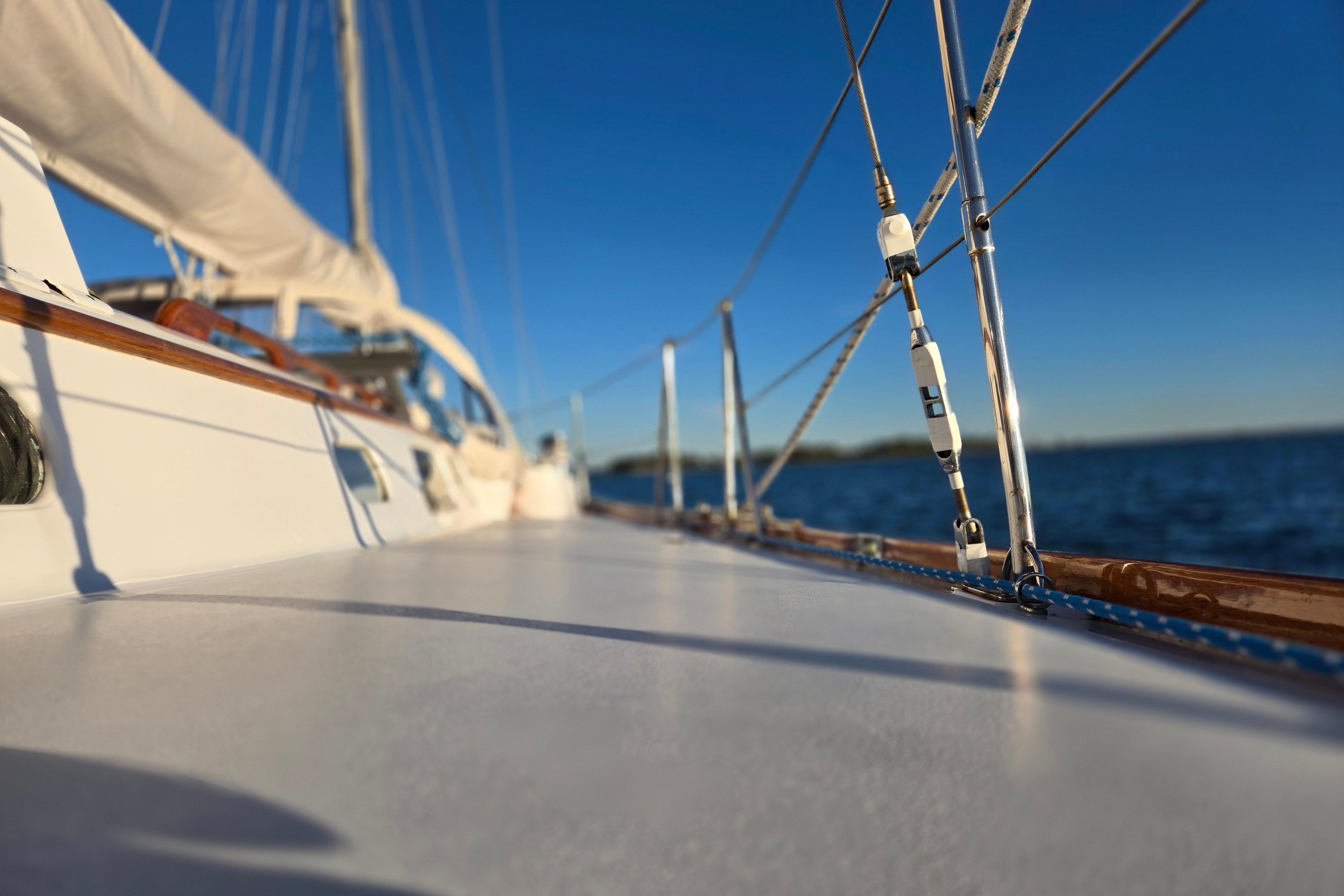 1970 Hinckley Bermuda 40 sailboat deck with rigging, sailing on calm blue waters.