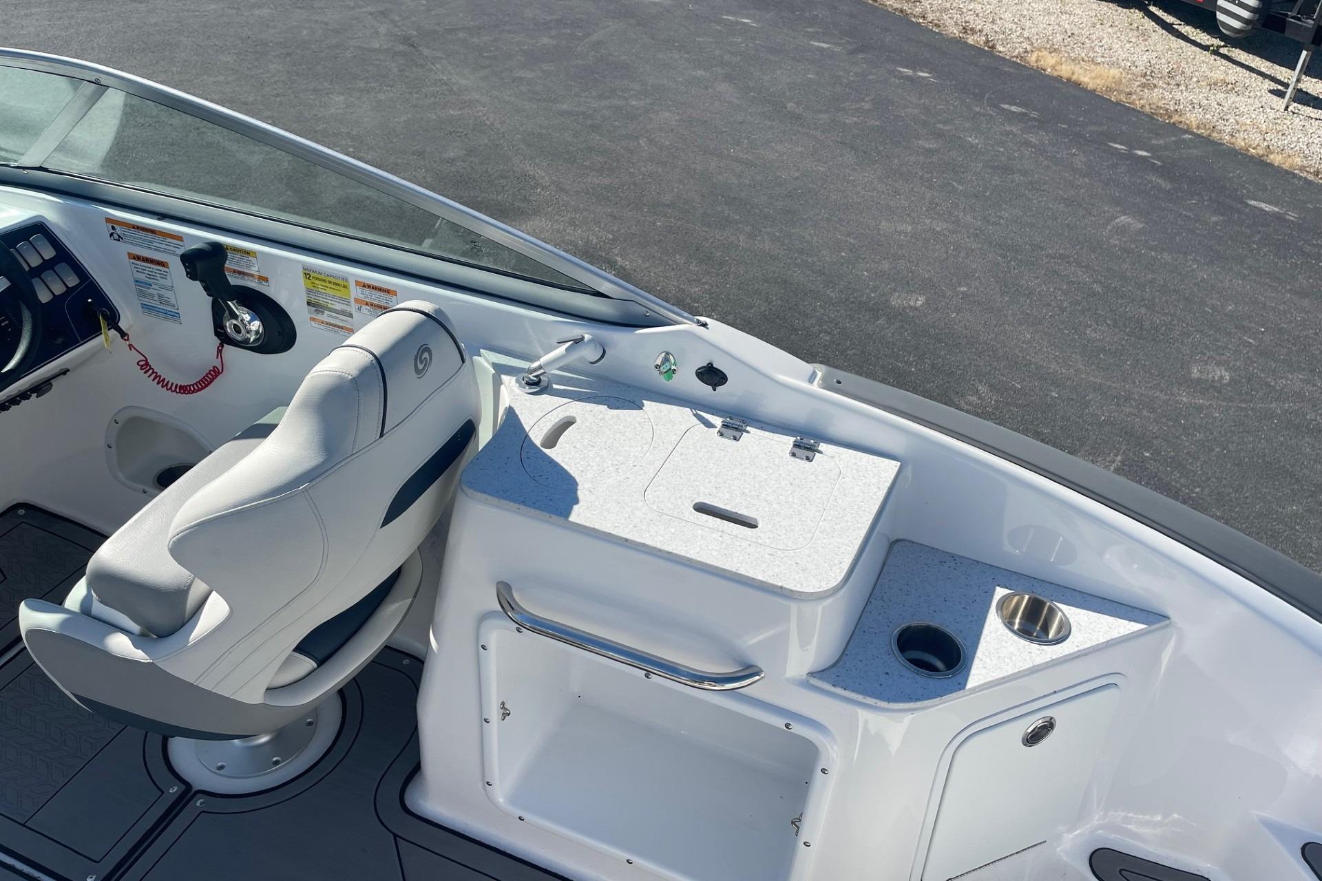 2023 Hurricane SunDeck 2400 OB boat interior with helm seat and console details.