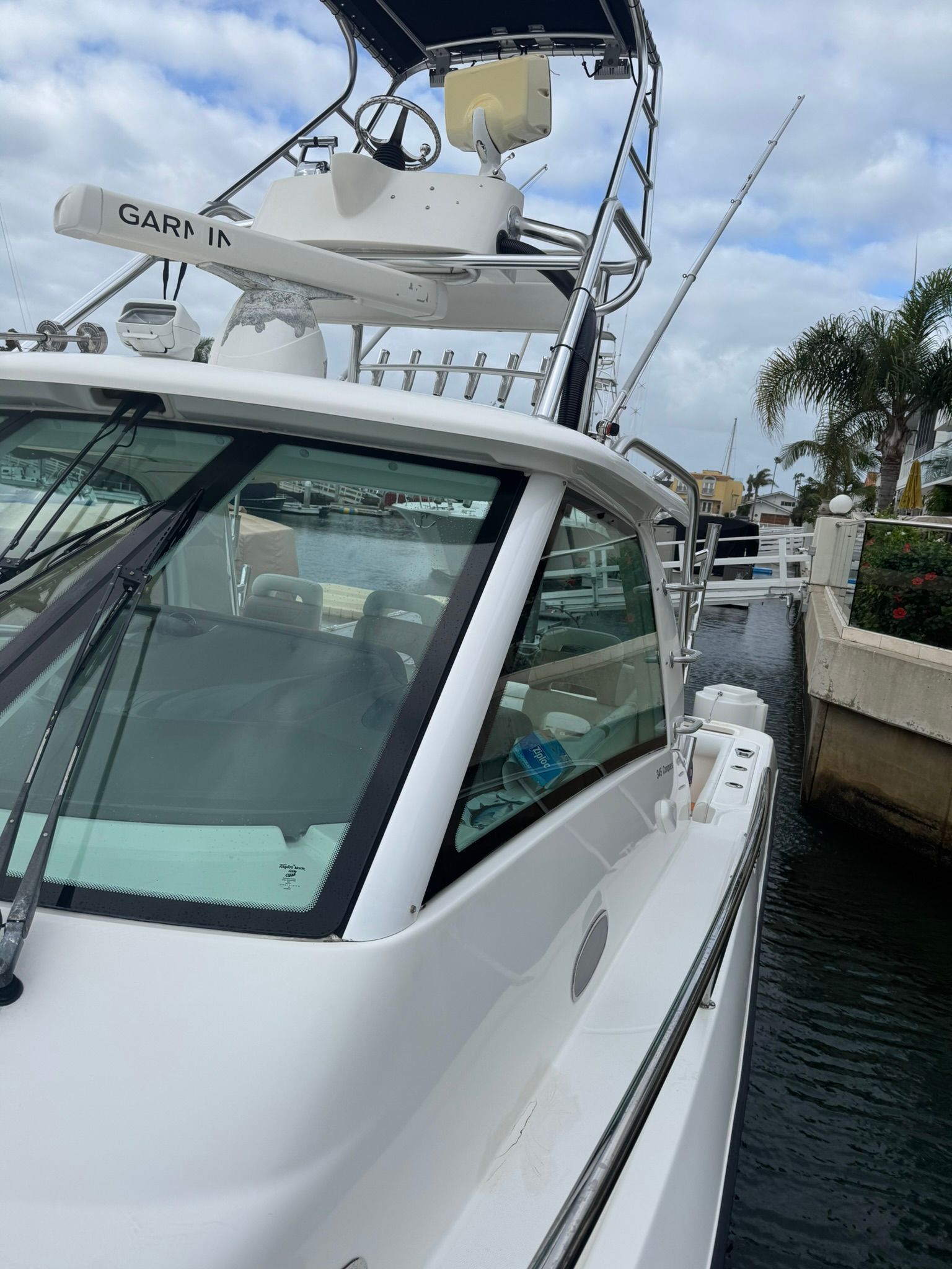A 2008 Boston Whaler 345 Conquest docked, featuring an elevated helm station.