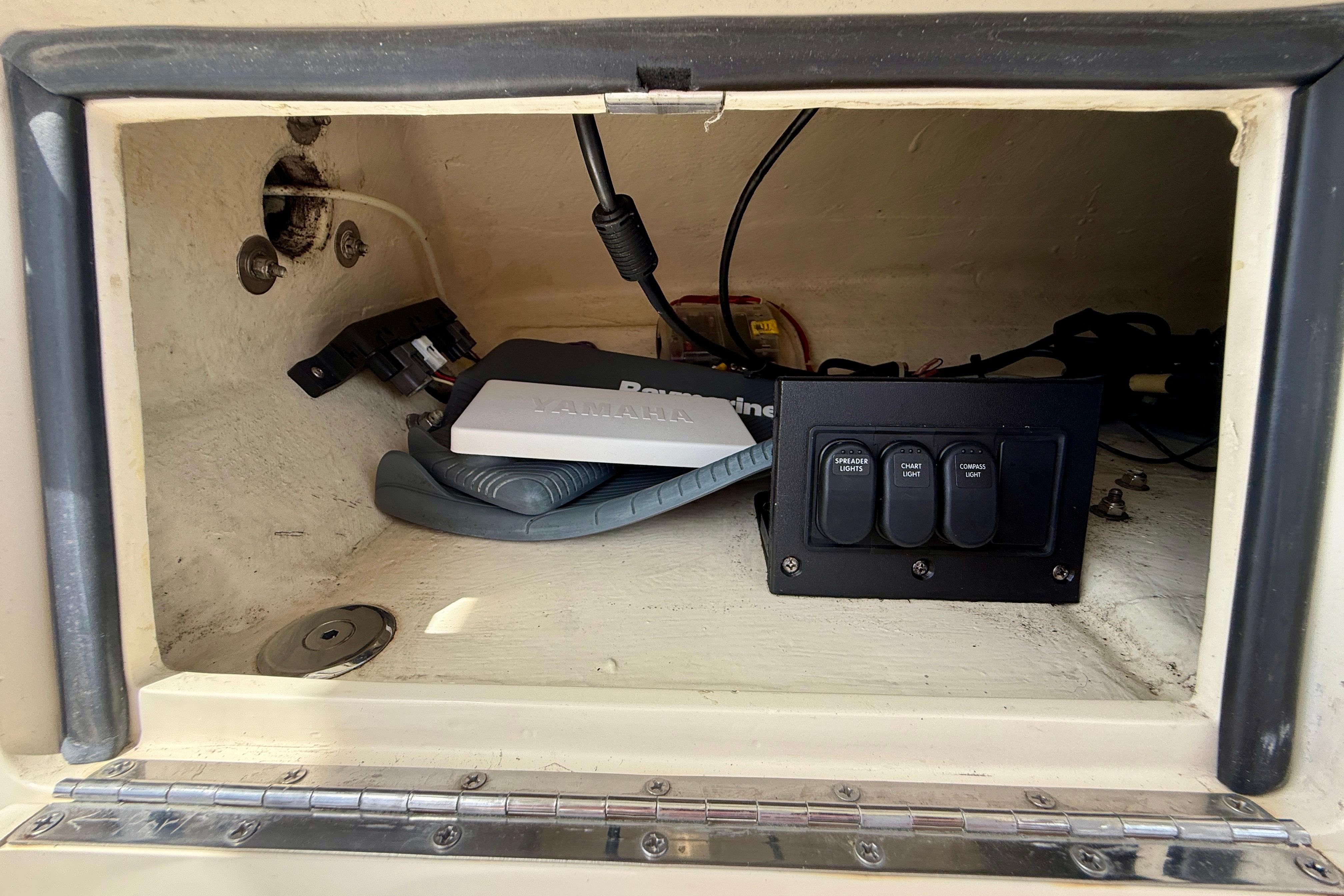 2012 Pursuit OS 345 Offshore boat compartment with electronic controls and wiring.