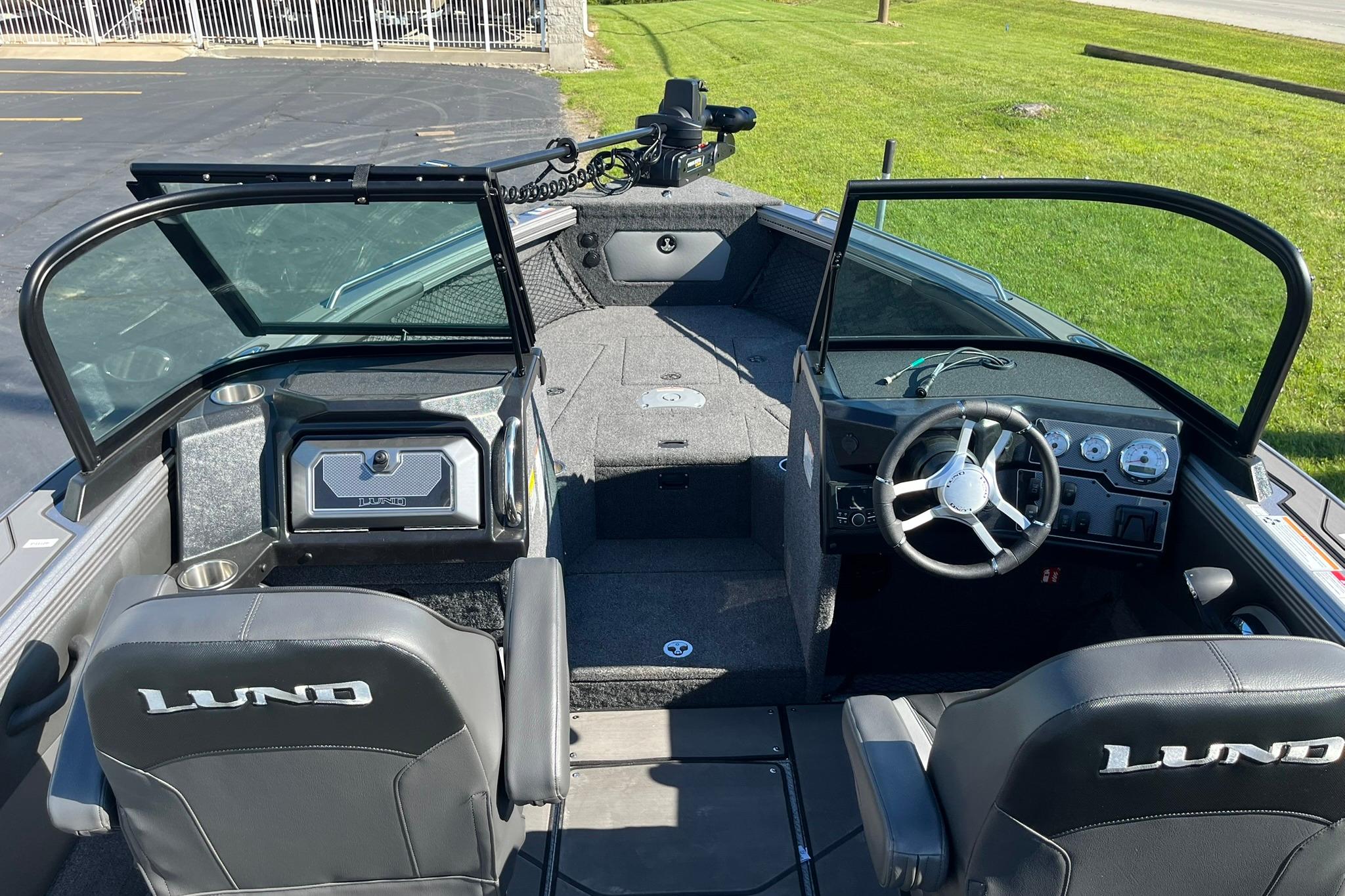 2026 Lund 2275 Baron boat interior with steering wheel, seating, and dashboard controls.