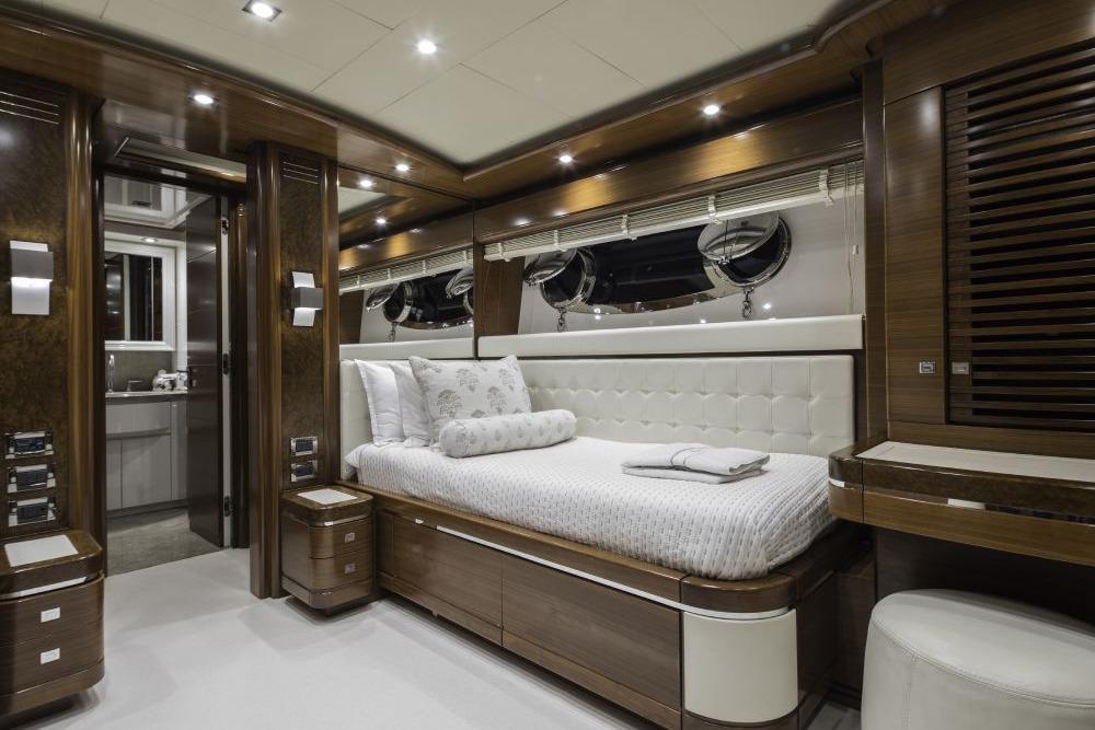 Luxurious CRN 129 yacht bedroom interior, 2009 model, featuring elegant wood finishes and modern design.