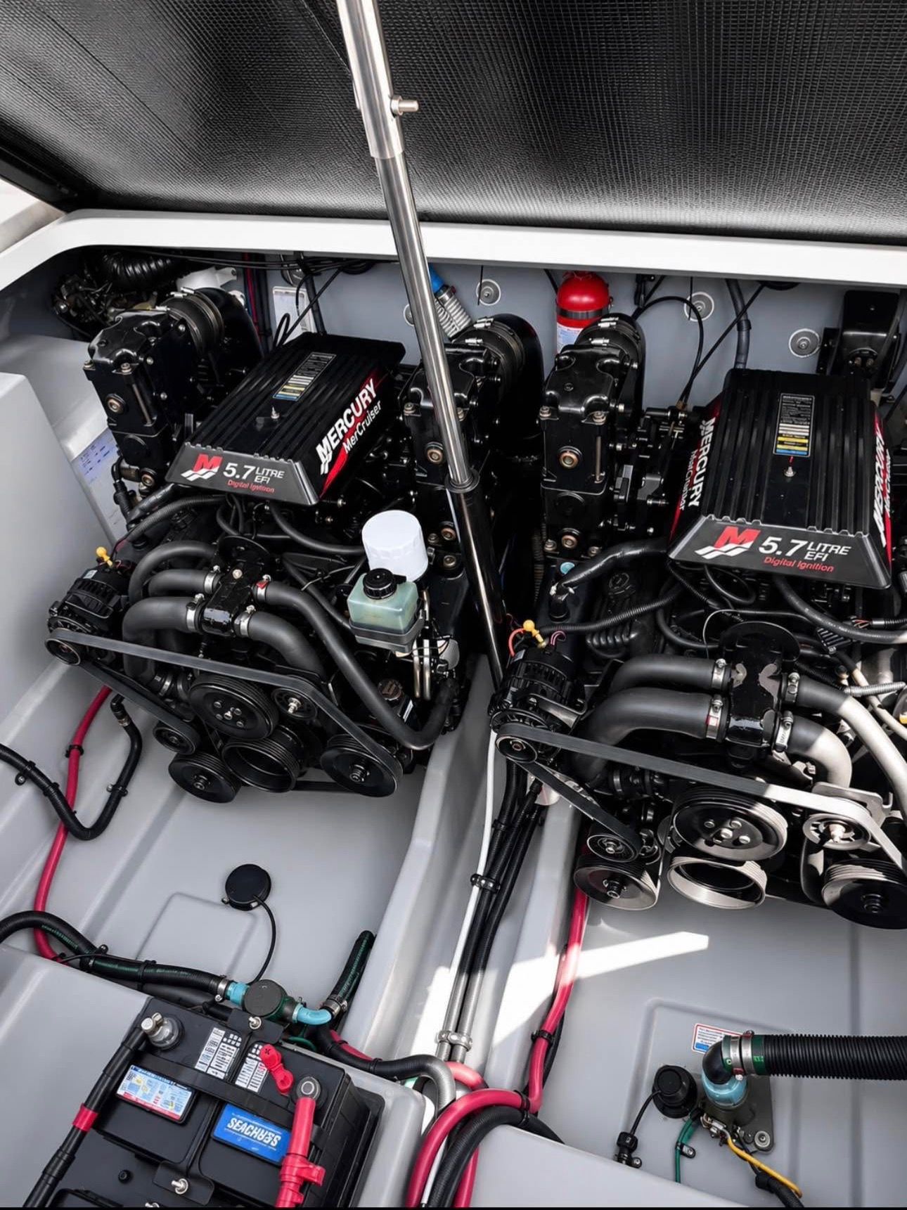 Engine compartment of a 2002 Sea Ray 300 Sundancer with twin Mercury engines.