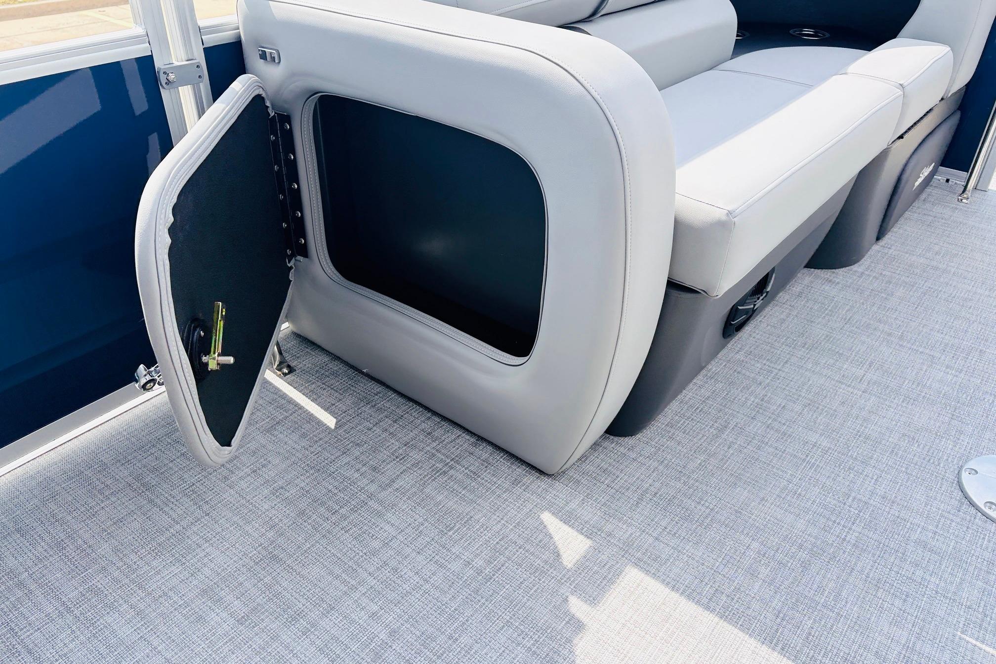 2026 Sun Tracker SportFish 22 DLX boat interior with open storage compartment and seating.