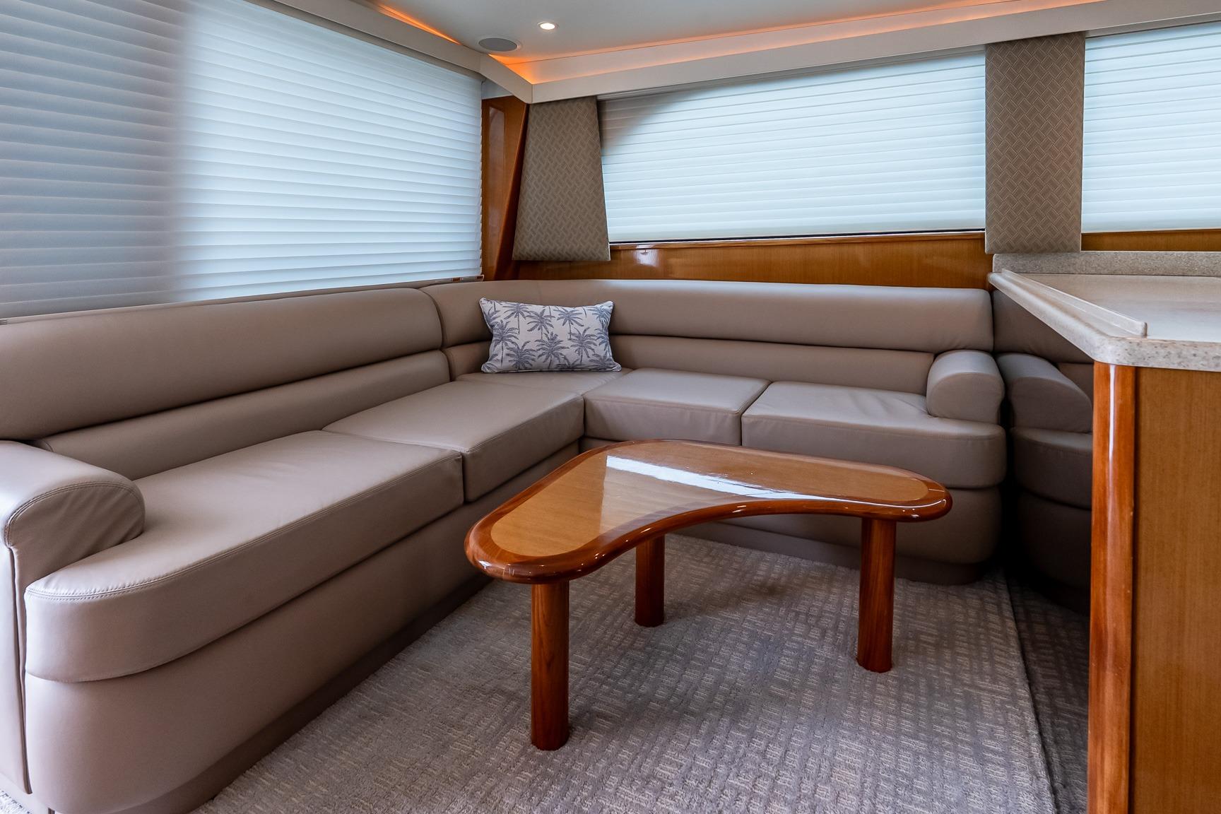 Luxurious interior of 2000 Viking 50' Convertible yacht with plush seating and elegant table.