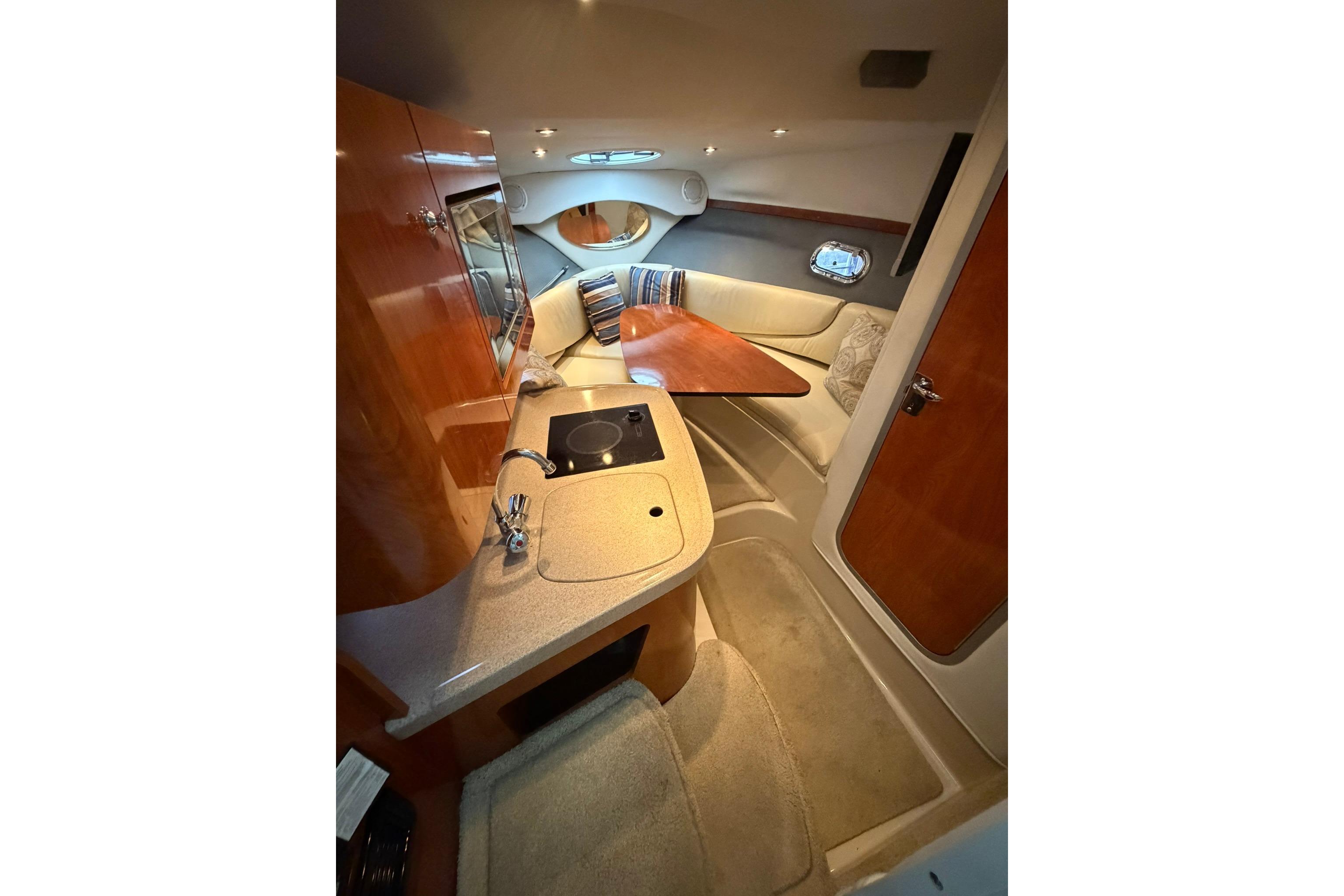 Interior of 2008 Four Winns V248 boat with kitchenette and seating area.