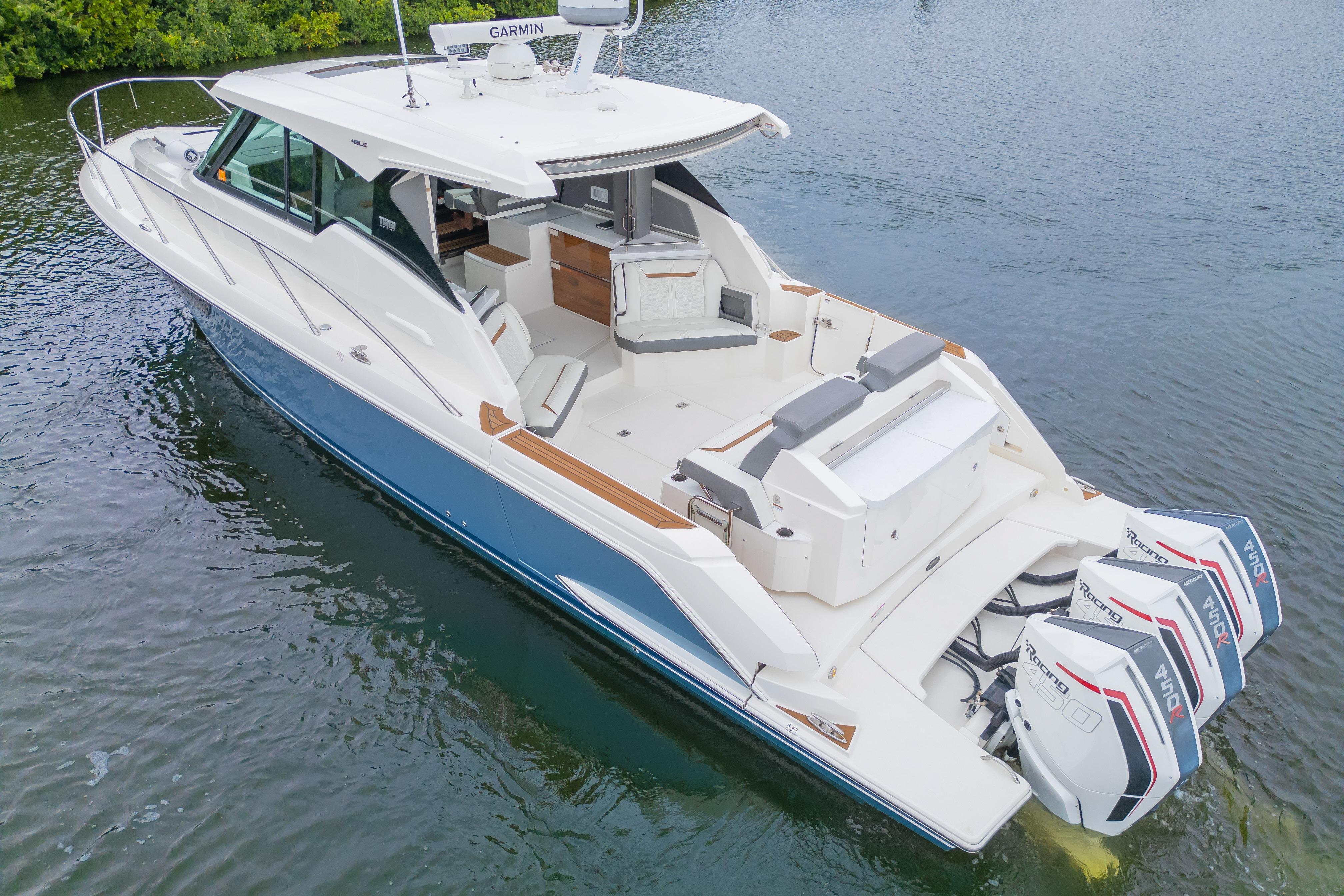 2021 Tiara Sport 43 LE luxury boat with triple outboard engines on calm water.