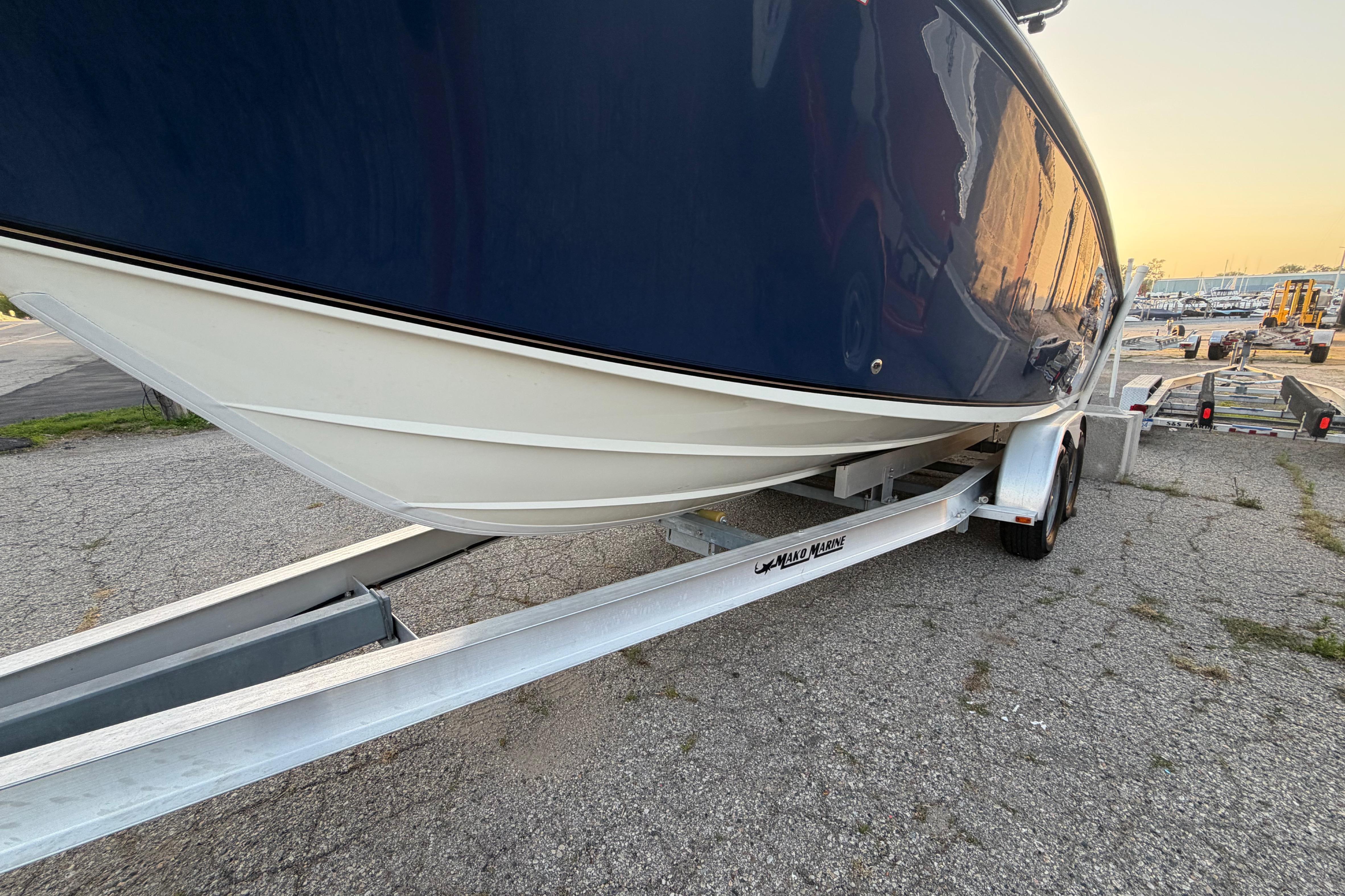 2007 Mako 234 Center Console boat on trailer at sunset.