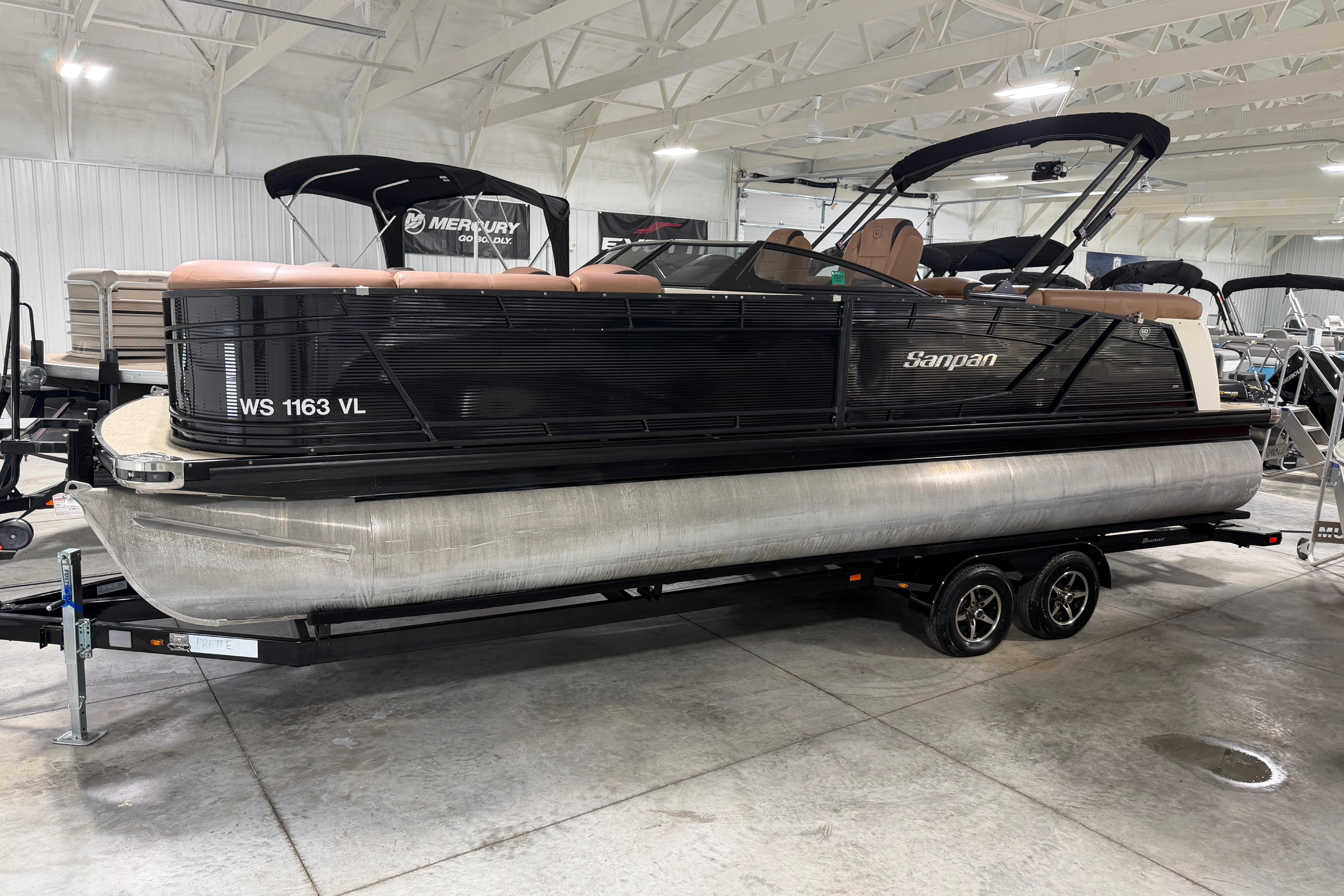 2018 Godfrey Sanpan 2500 ULC pontoon boat on trailer in indoor showroom.