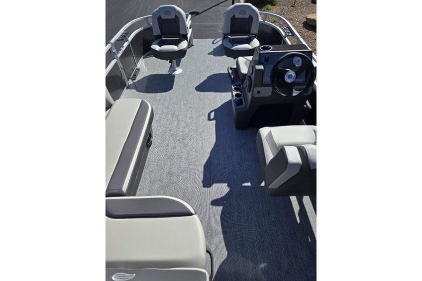 2026 Sun Tracker Bass Buggy 16 XL Select pontoon boat interior with seating and steering console.