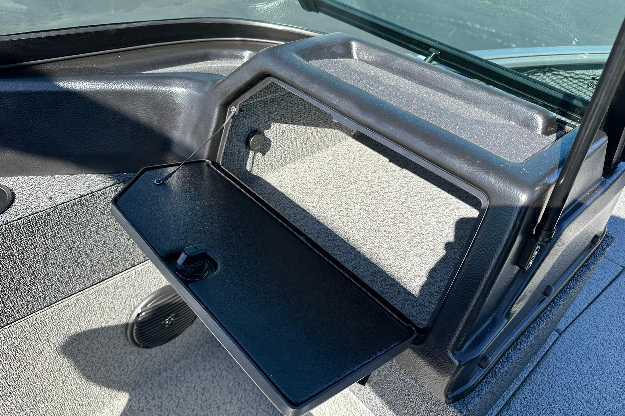 Interior of 2026 Lund 1875 Impact XS Sport boat with open storage compartment.