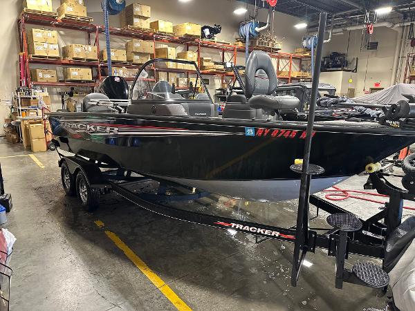 2023 Tracker Targa V-18 WT boat in warehouse, black exterior, on trailer.