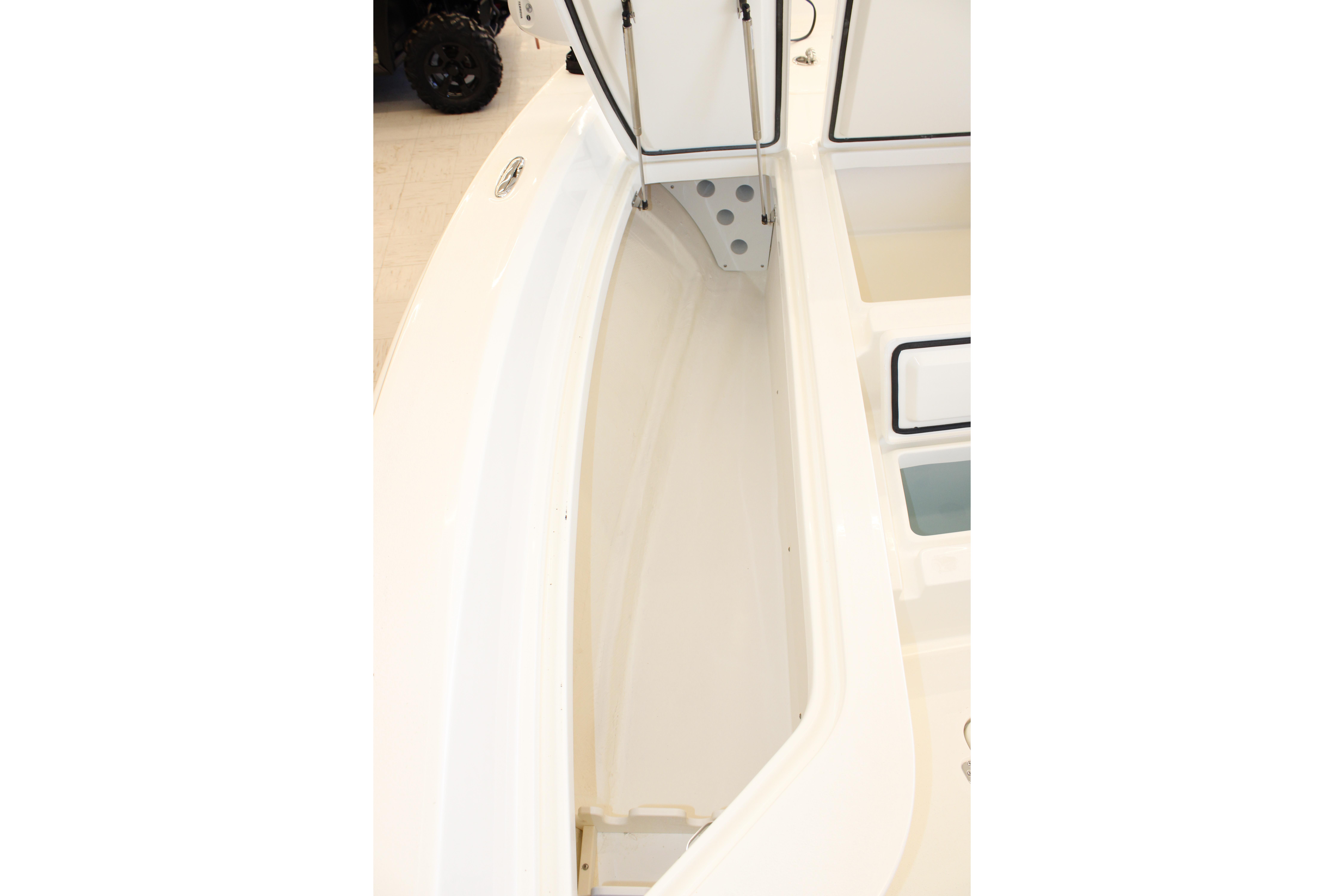 2026 Mako 24 APEX boat interior storage compartment, open hatch view.