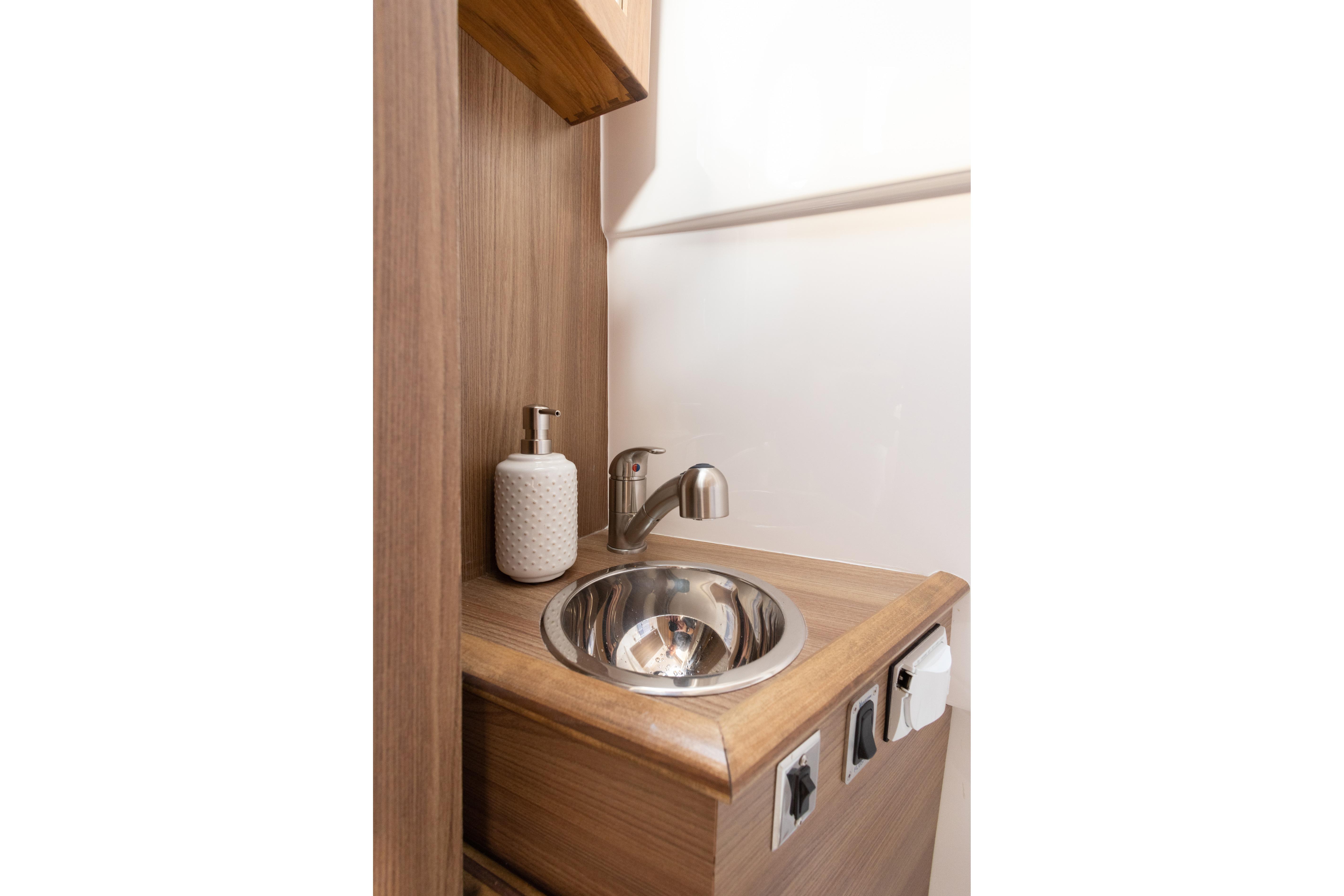 Compact sink area in Solara S-310 CW 2025, featuring modern faucet and soap dispenser.