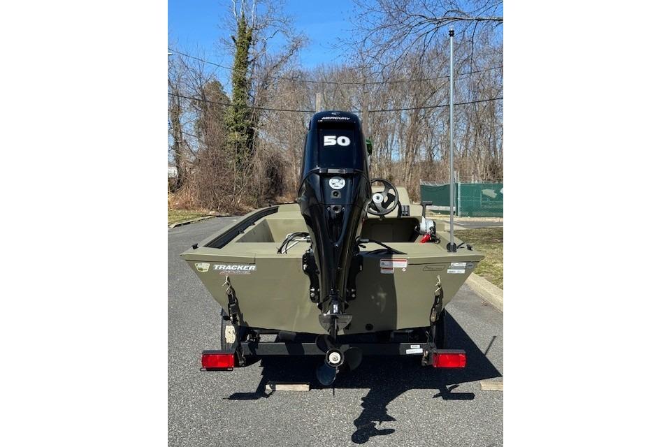 2026 Tracker Grizzly 1648 SC boat with Mercury 50 engine, parked outdoors.