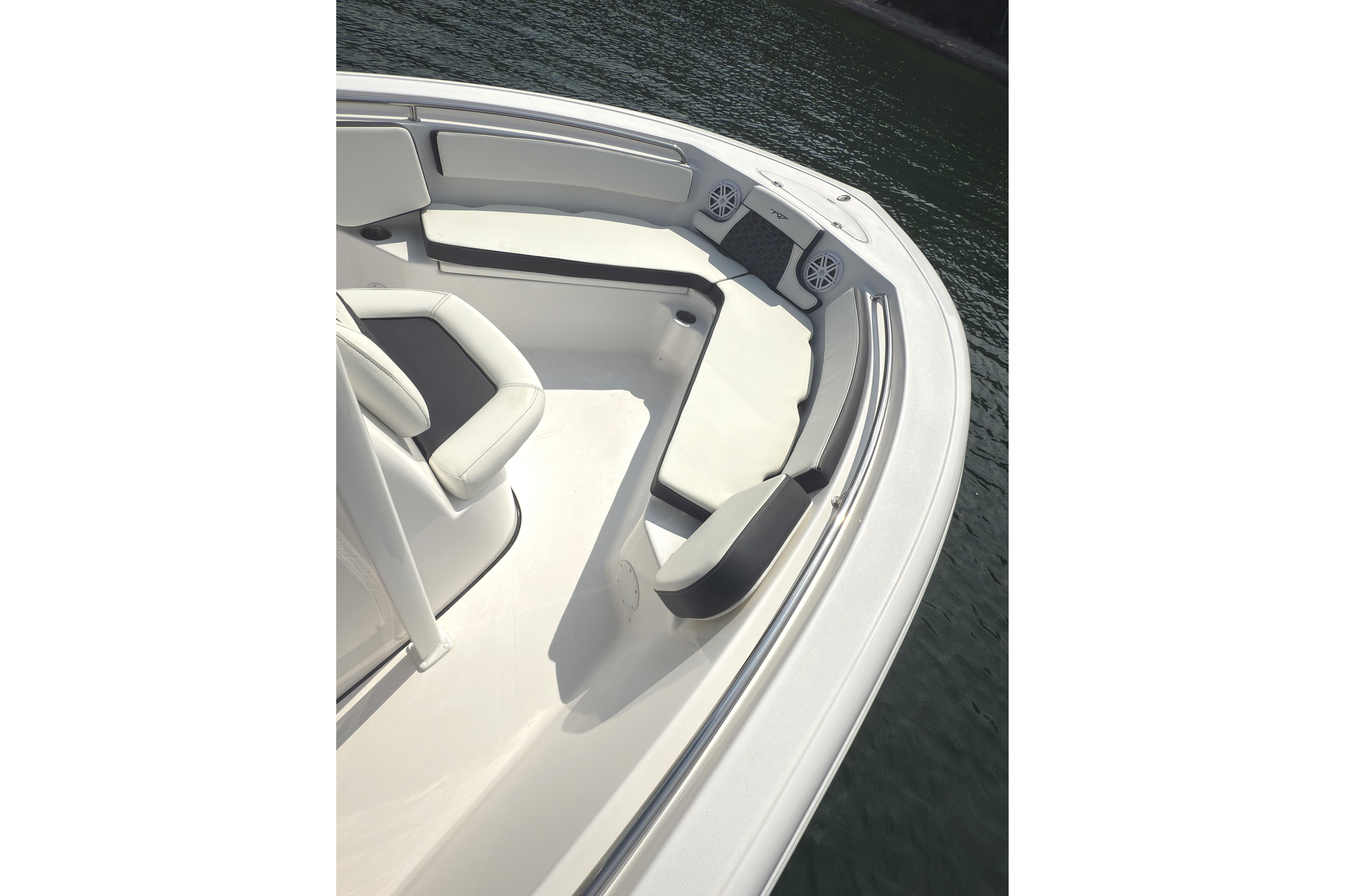 2026 Tidewater 210 CC Adventure boat interior with seating, on calm water.