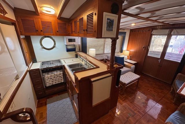 1986 Krogen 42 Classic yacht interior with wooden cabinetry and cozy seating area.