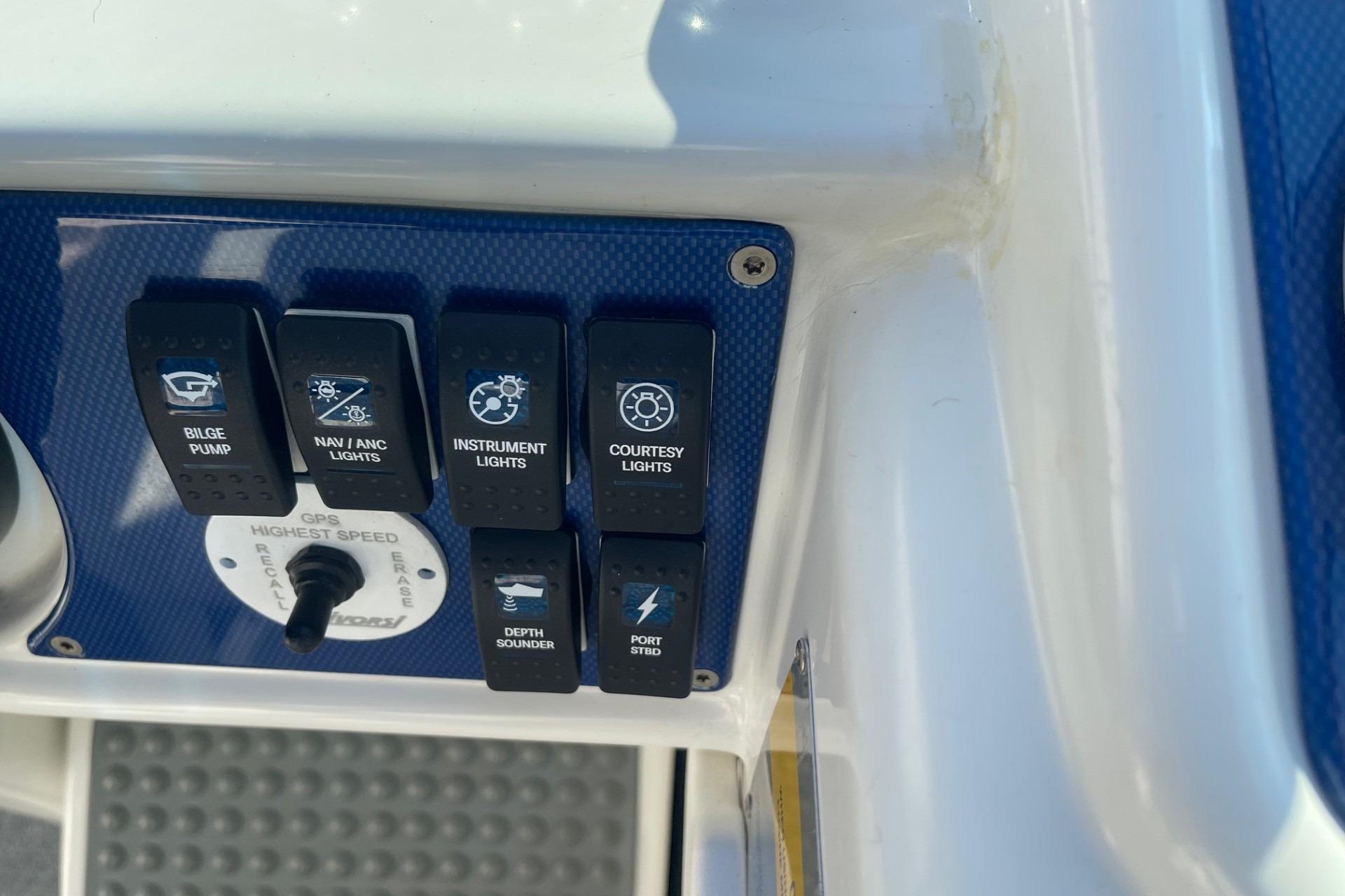Control panel of a 2004 Formula 382 FASTech boat with various switches and GPS settings.