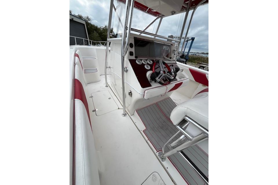 2001 Fountain 38 Center Console boat interior with red and white seating and control panel.