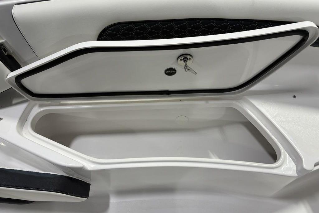 Storage compartment of 2026 Tidewater 232 CC Adventure boat, featuring secure lock and key.