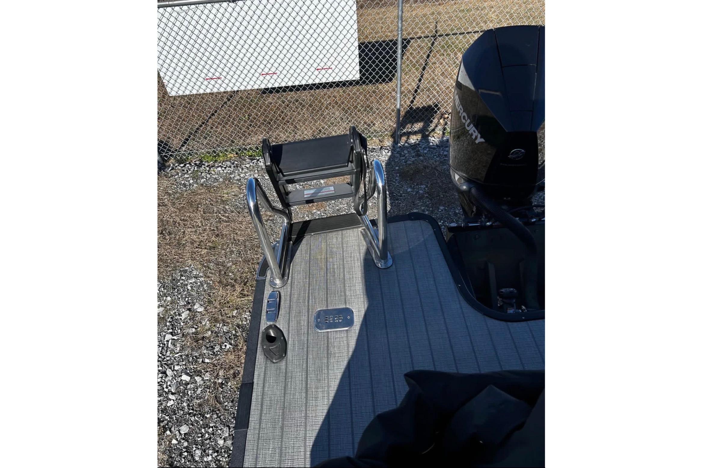 2023 Starcraft MX 25 DL DH boat deck with ladder and Mercury engine.