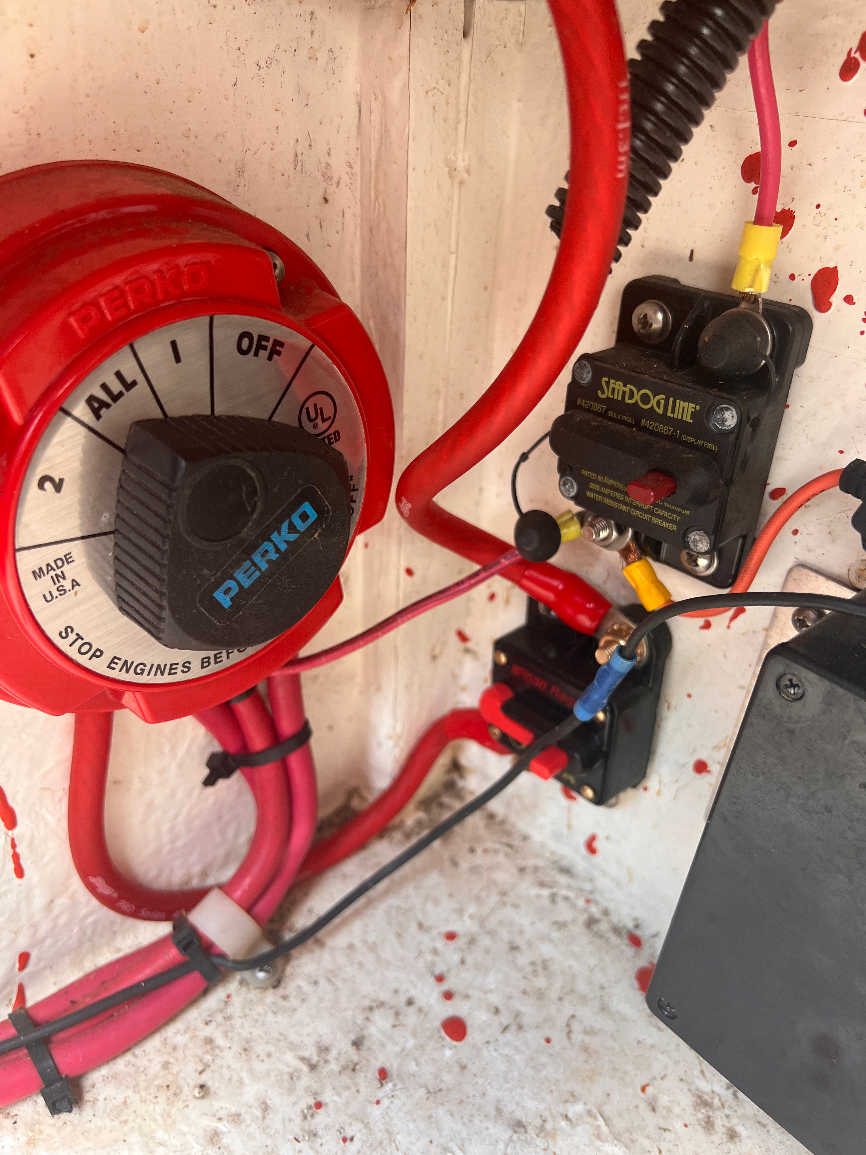 Close-up of a boat switch with red wiring.