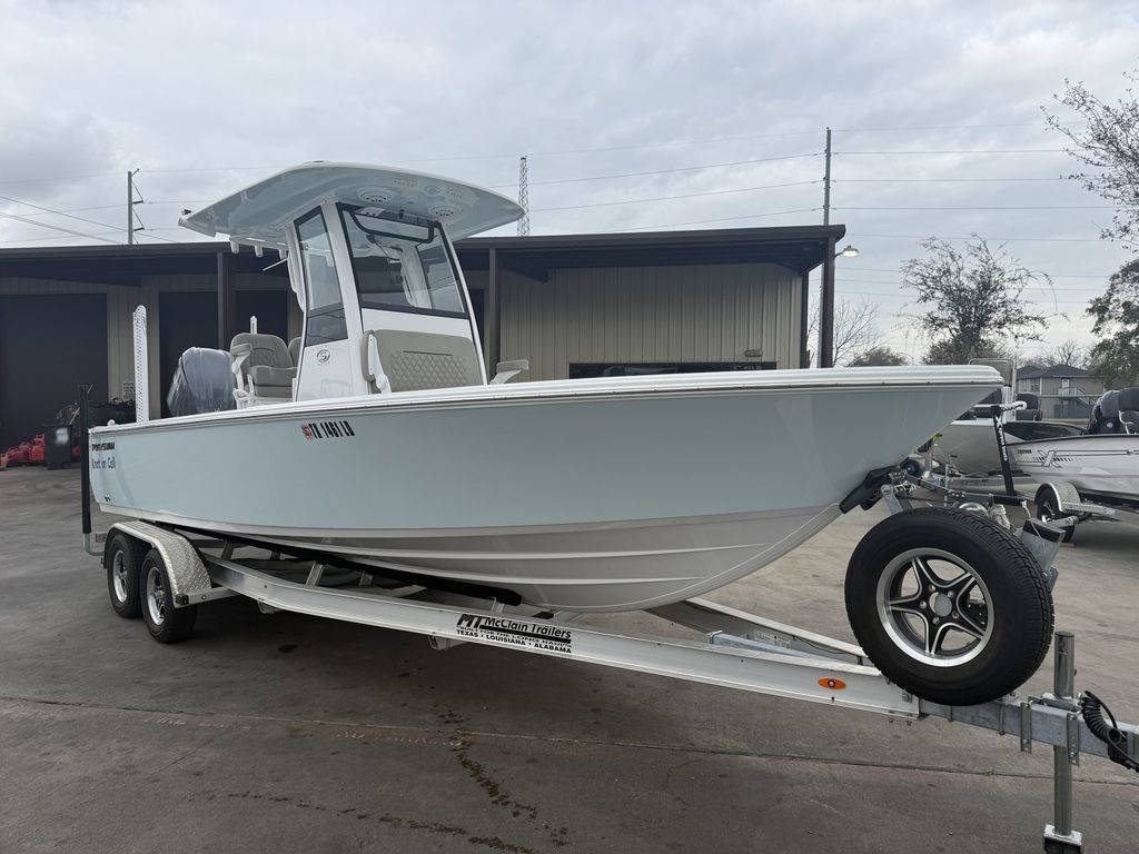 A 2025 Sportsman Masters 247OE Bay Boat on a trailer in front of a building.