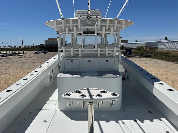 2022 Freeman 42LR boat interior with rod holders and seating, docked under clear blue sky.