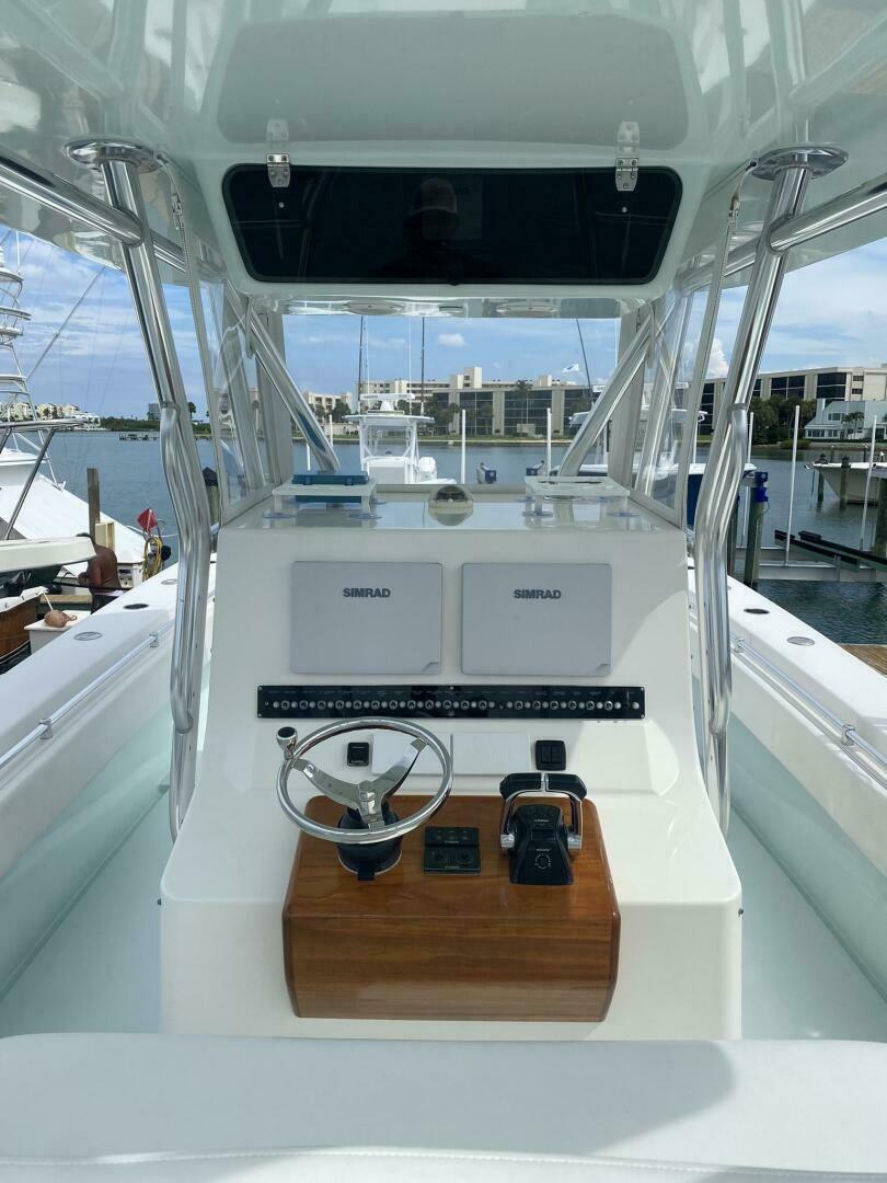 2012 Contender 39ST boat helm with dual Simrad displays, docked at marina.