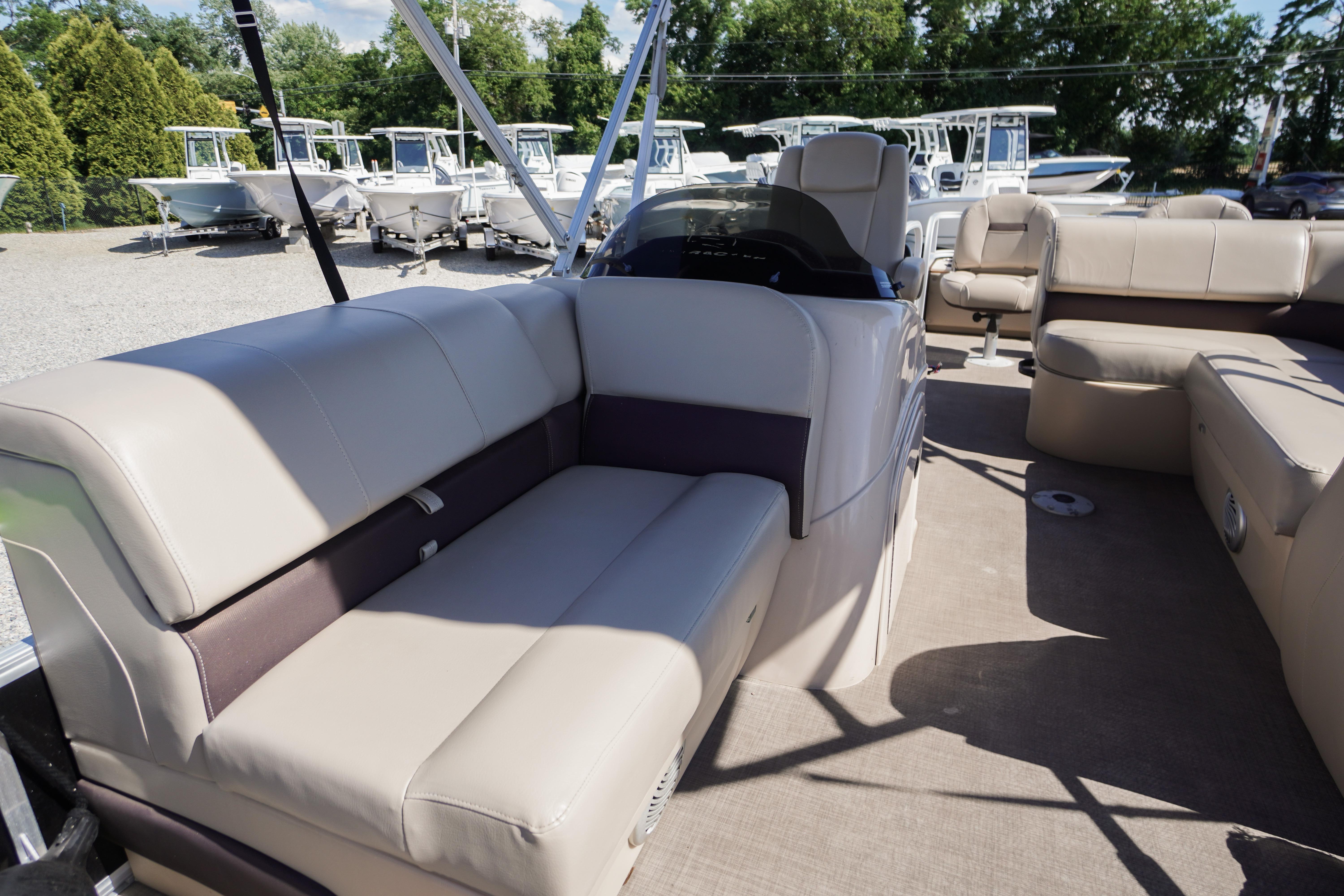 2019 SUNTRACKER Fishin' Barge 22 DLX interior with beige seating and spacious layout.