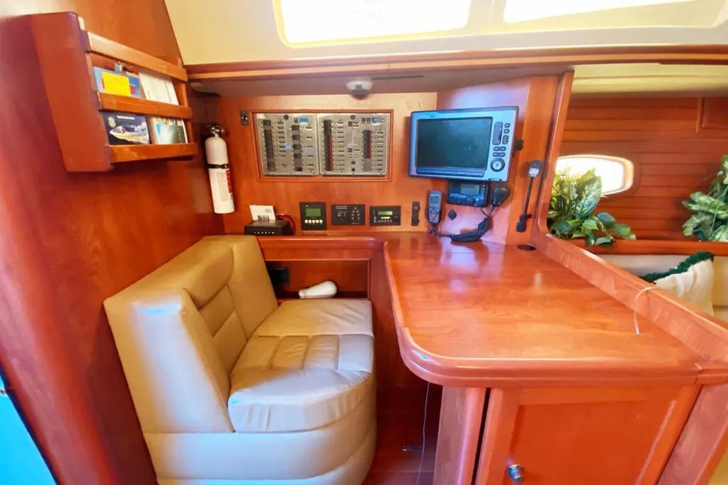 Luxurious 2012 Hunter Aft Cockpit 50 yacht interior with navigation station and plush seating.
