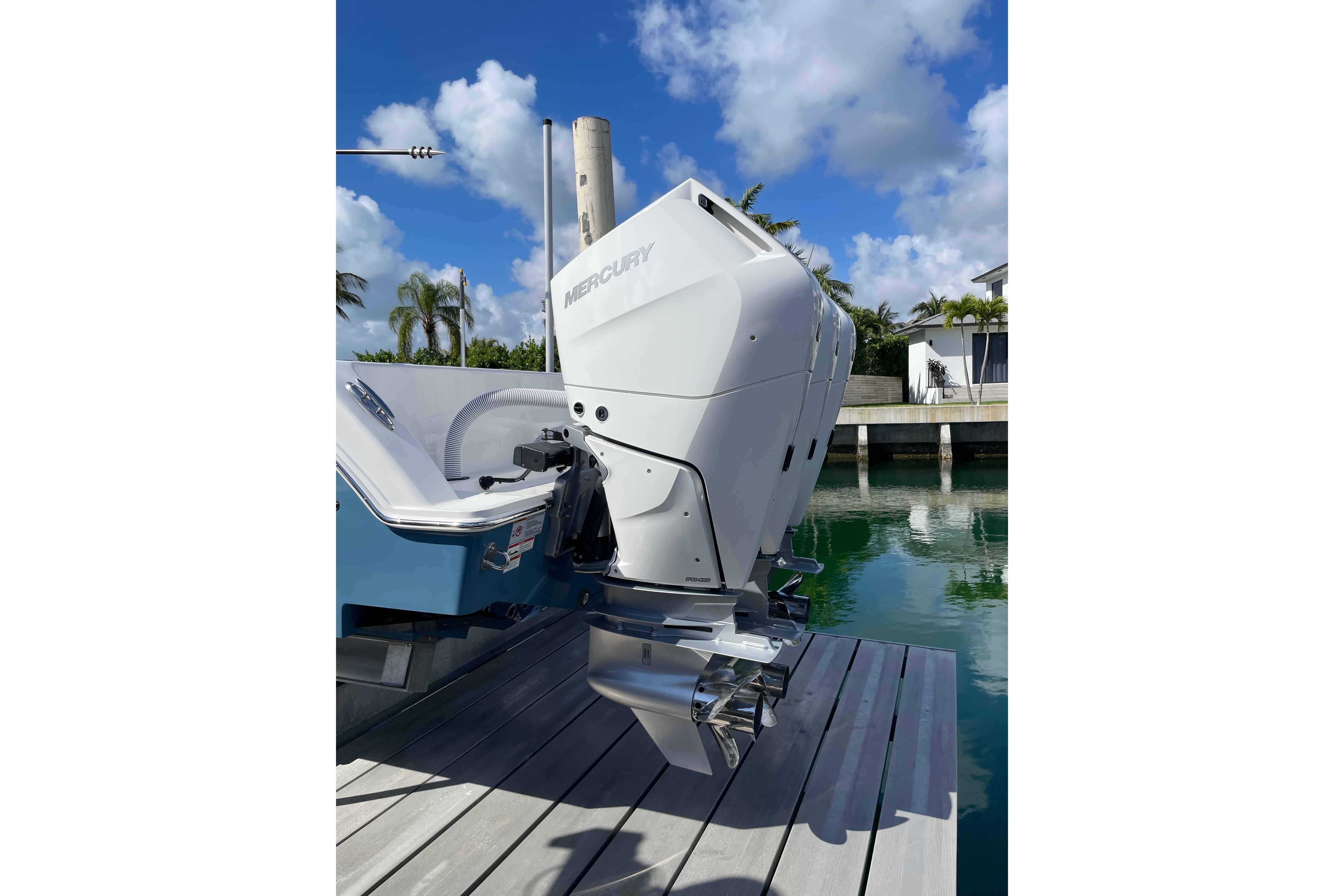 2024 Invincible 36 Open Fisherman with Mercury outboard engine docked by water.
