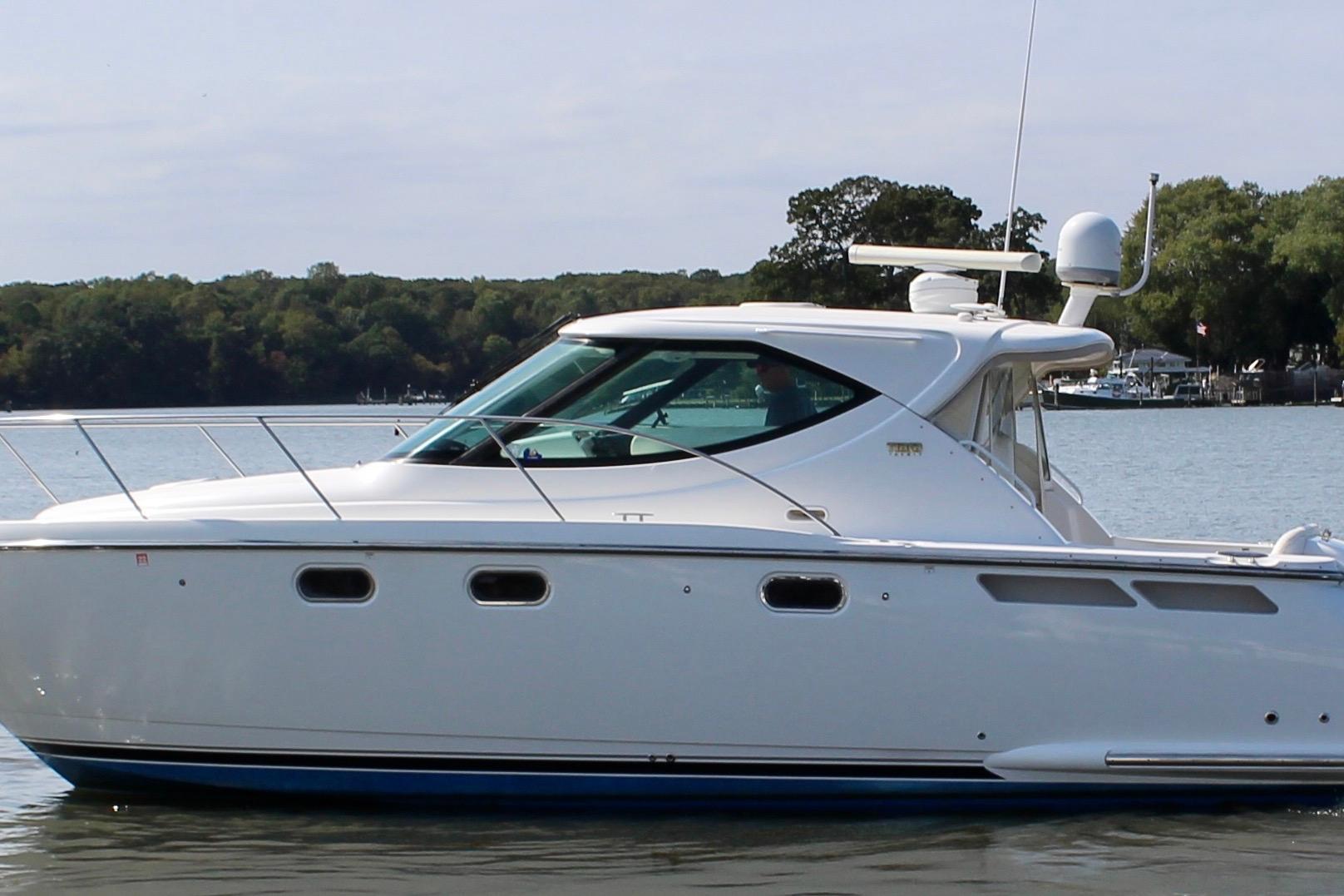 2008 Tiara Yachts 3500 Sovran cruising on calm waters, side view.