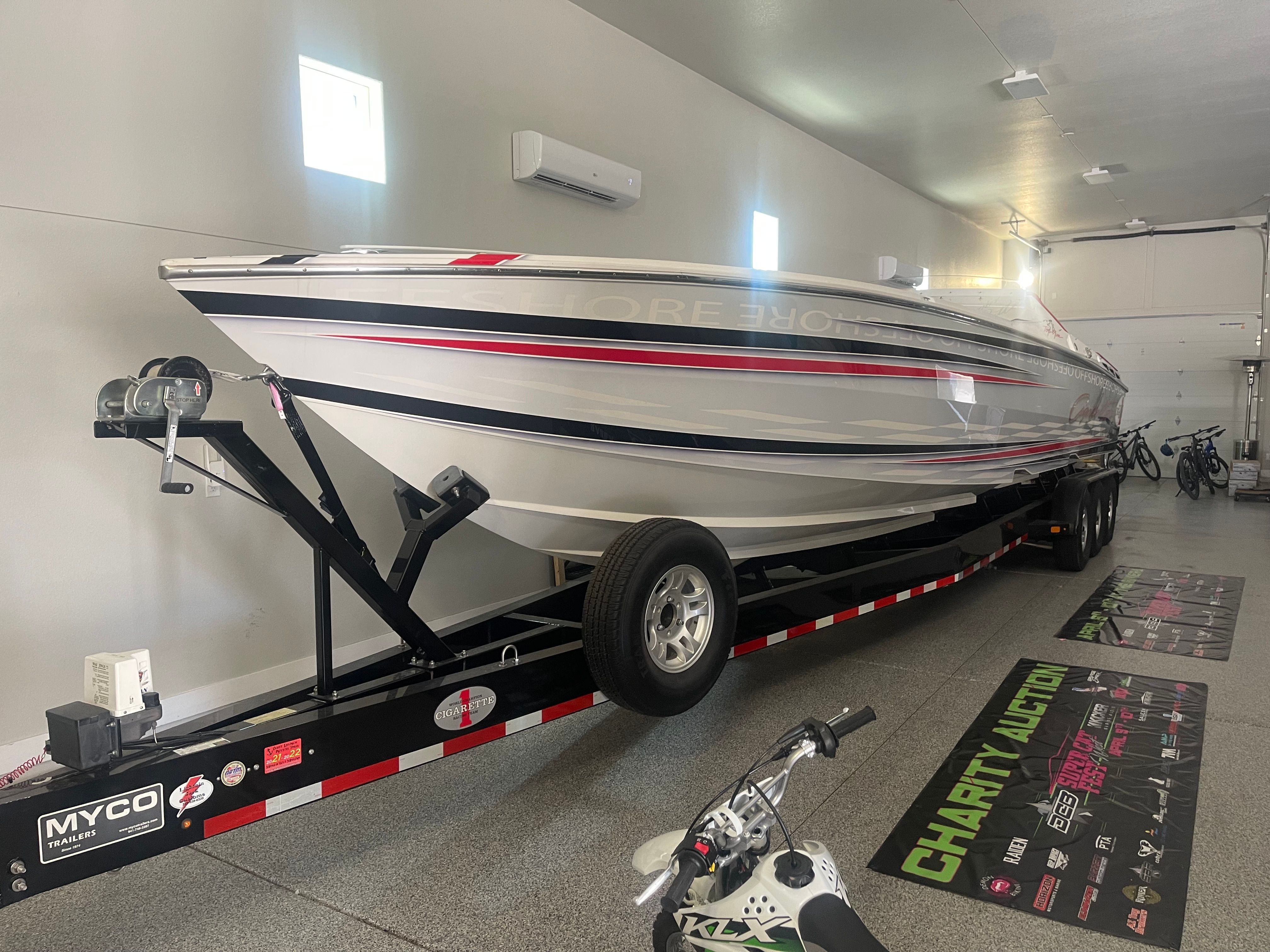 2004 Cigarette 38' Top Gun boat on trailer in garage.