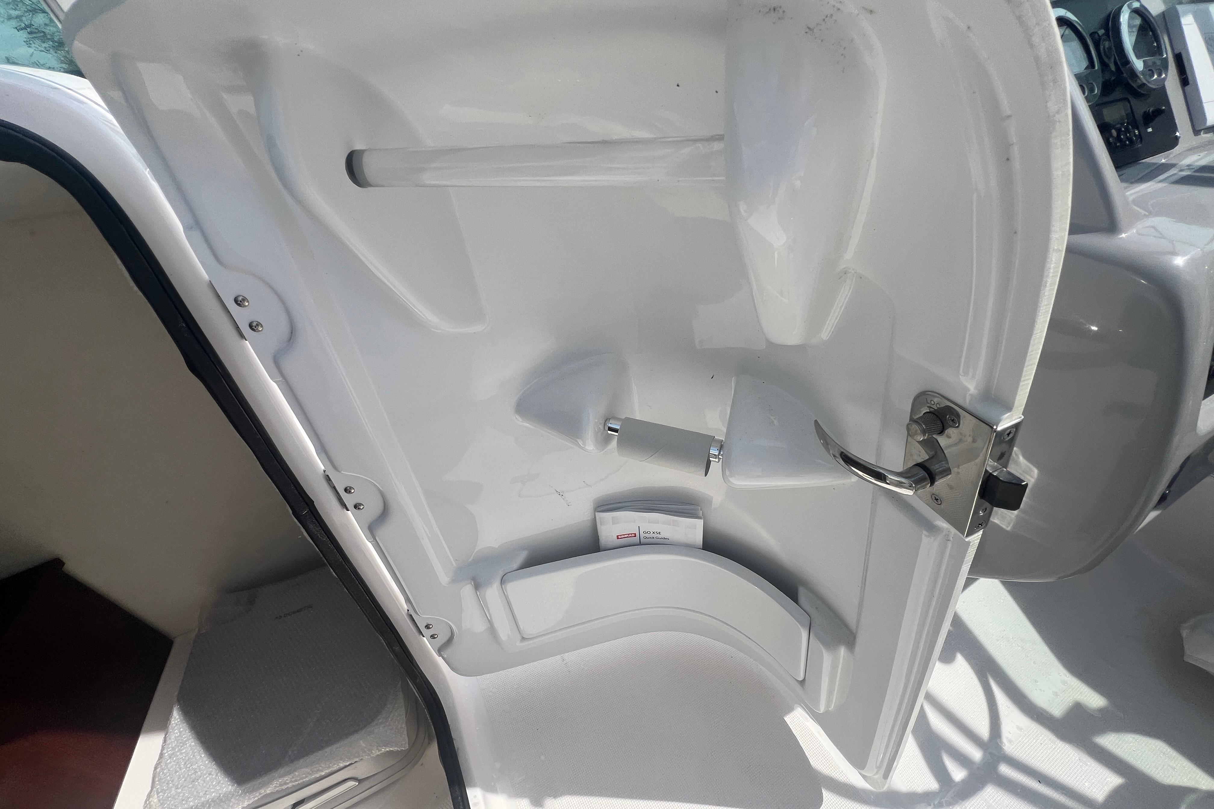 2022 Robalo R227 Dual Console interior door with handle and storage compartment.