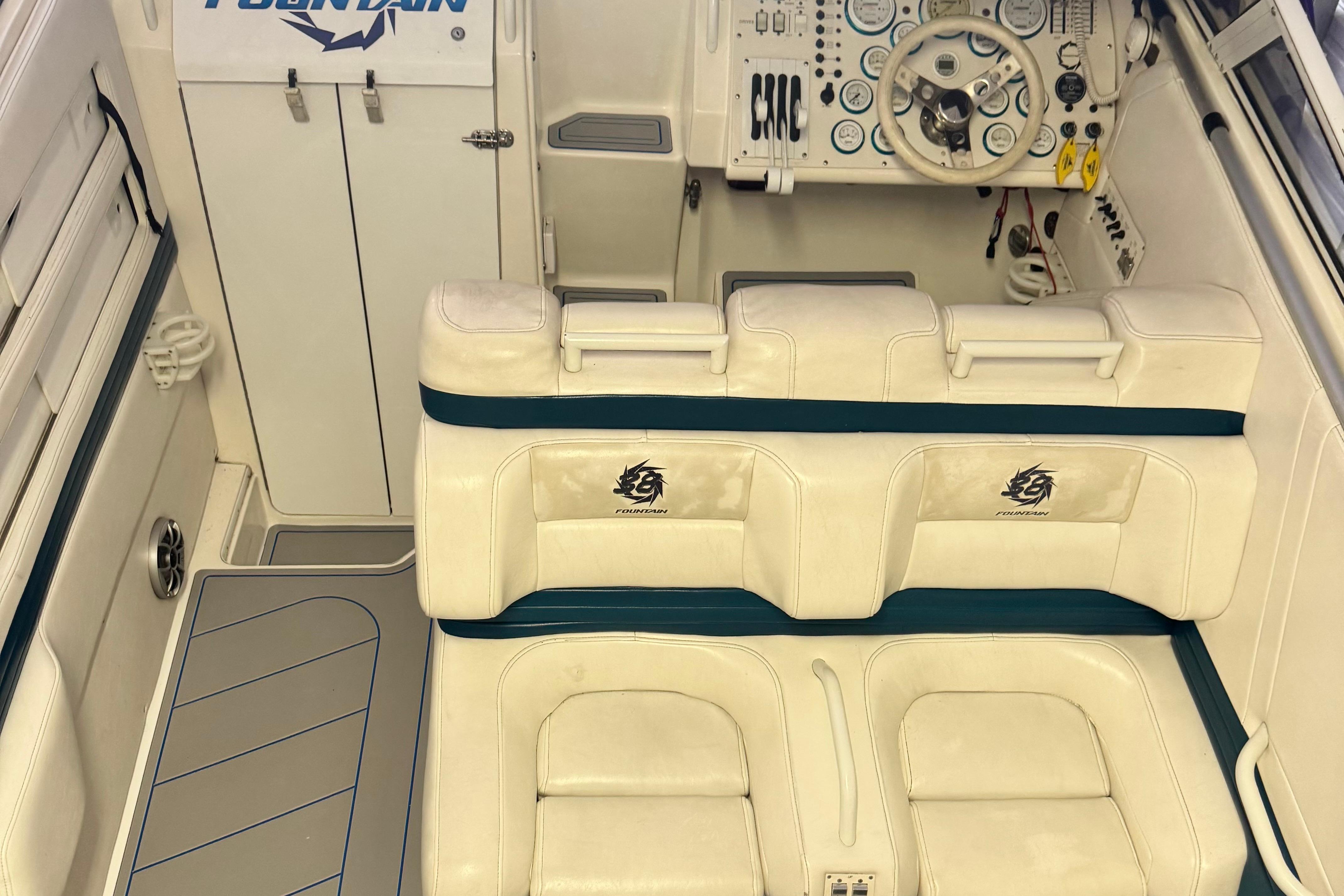 1999 Fountain 38 SC boat interior with white seating and control panel.
