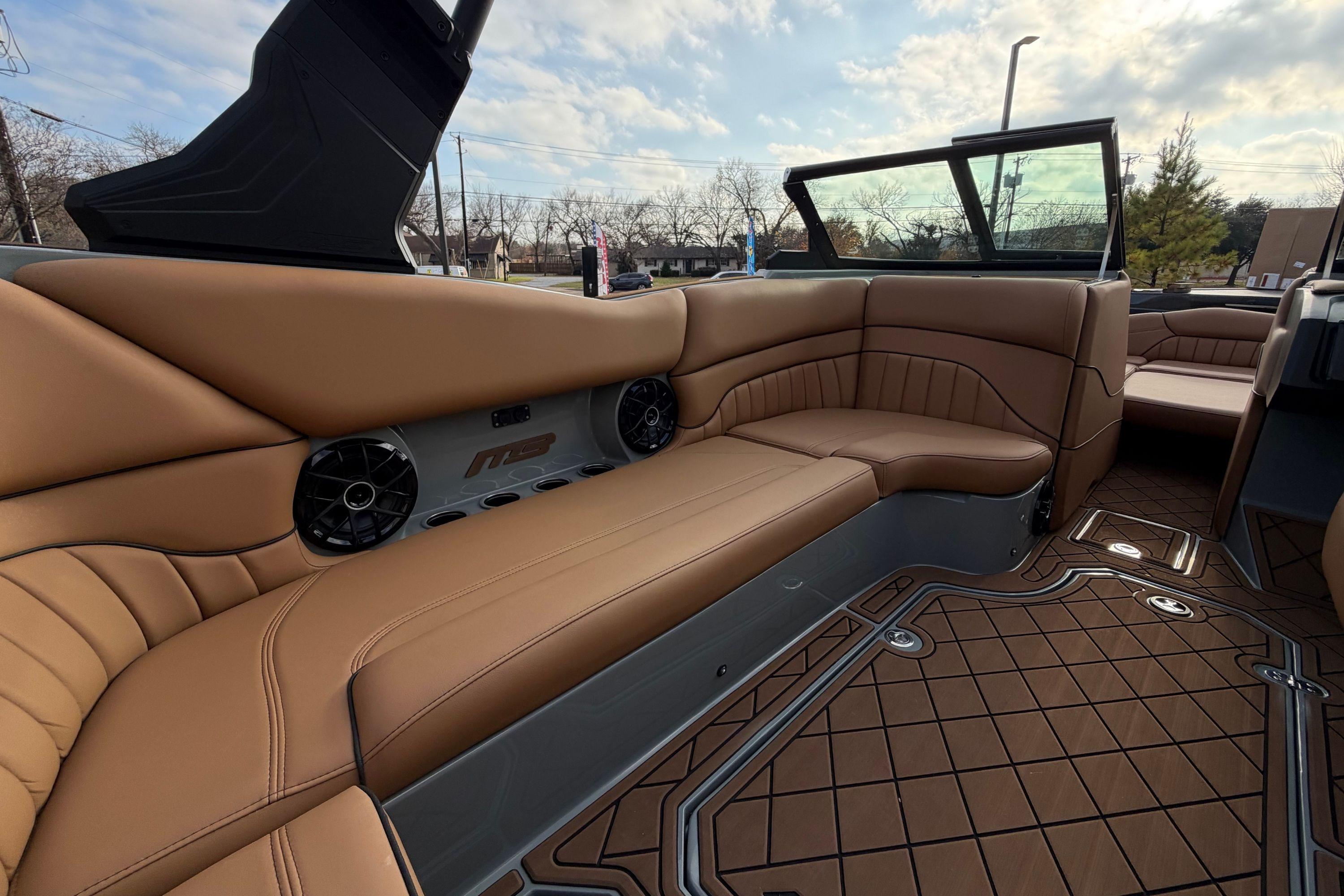 Luxurious interior of 2026 MB B52 21 Alpha boat with tan leather seating.