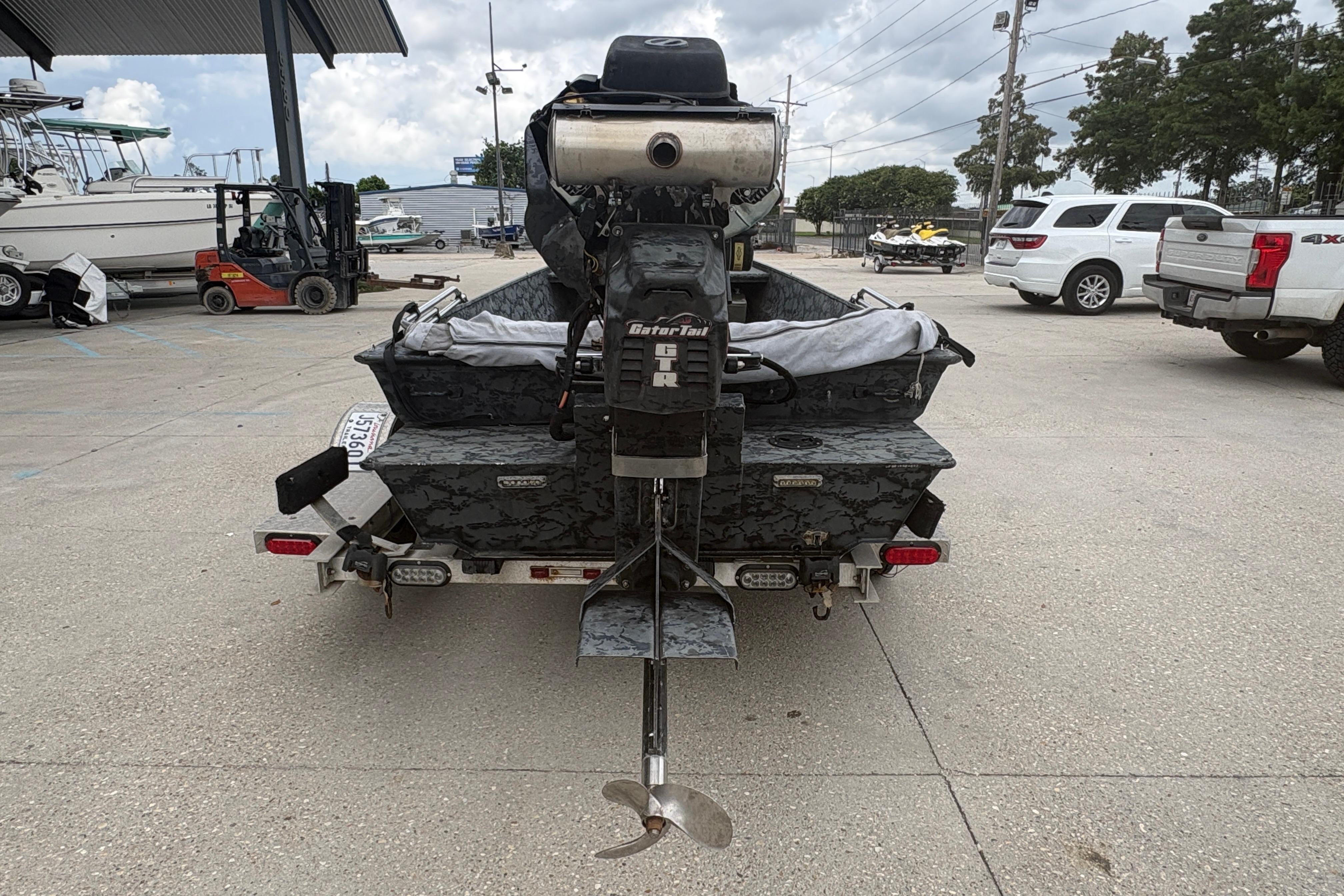 2020 Gator Tail Extreme boat with motor, parked in a marina lot.