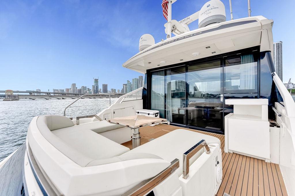 Luxury Fairline Targa 58 yacht, 2012 model, docked with city skyline view.