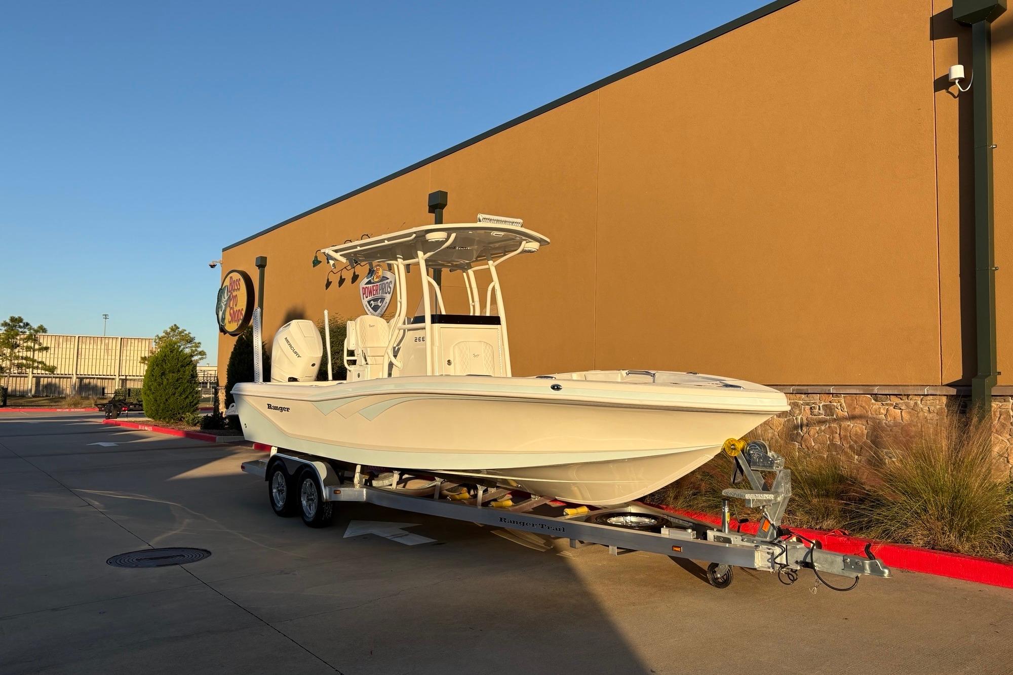 2026 Ranger 2660 Bay boat on trailer outside a store, in bright sunlight.