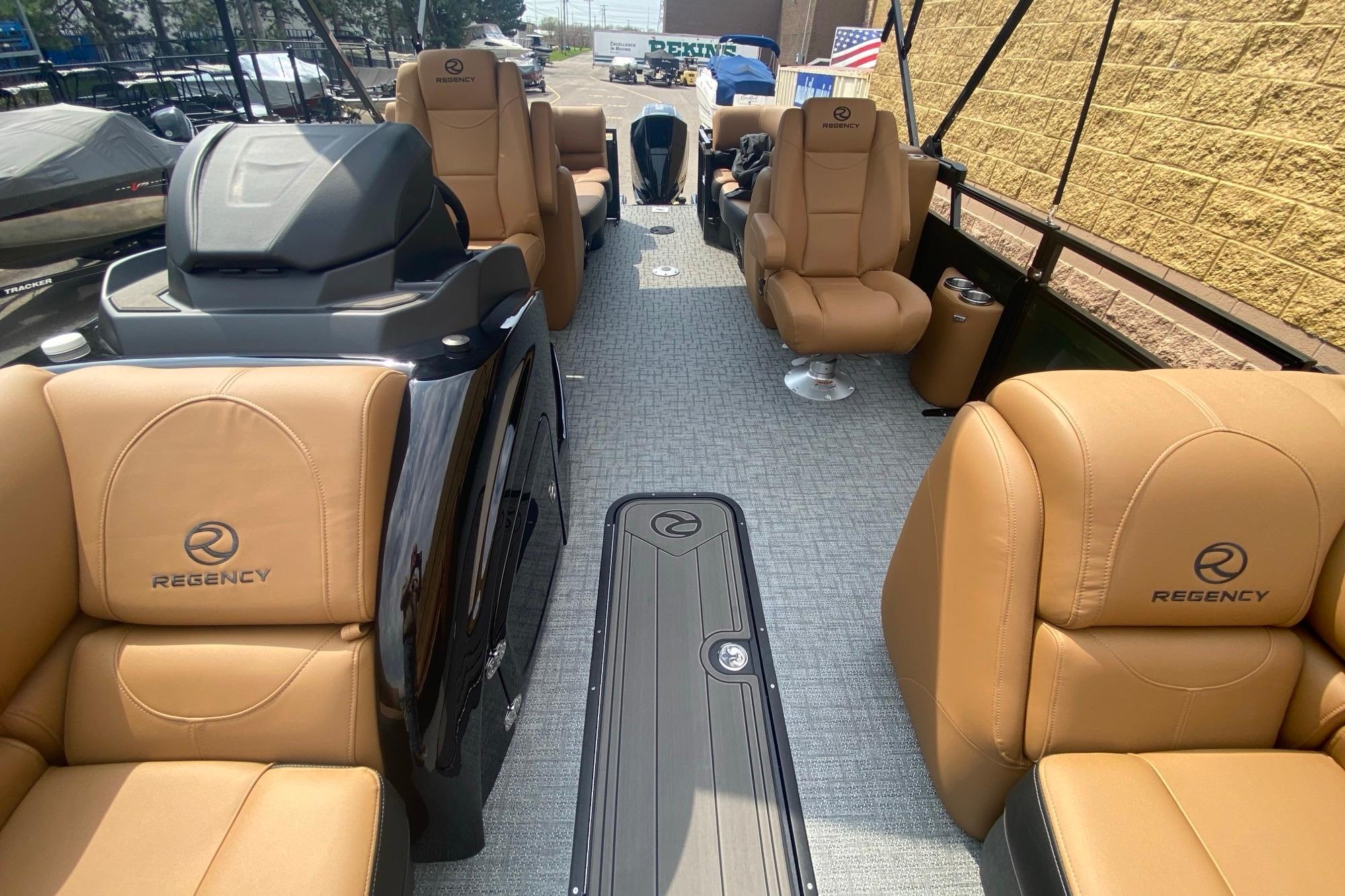 Luxurious interior of 2026 Regency 230 DL boat with tan leather seating and modern design.