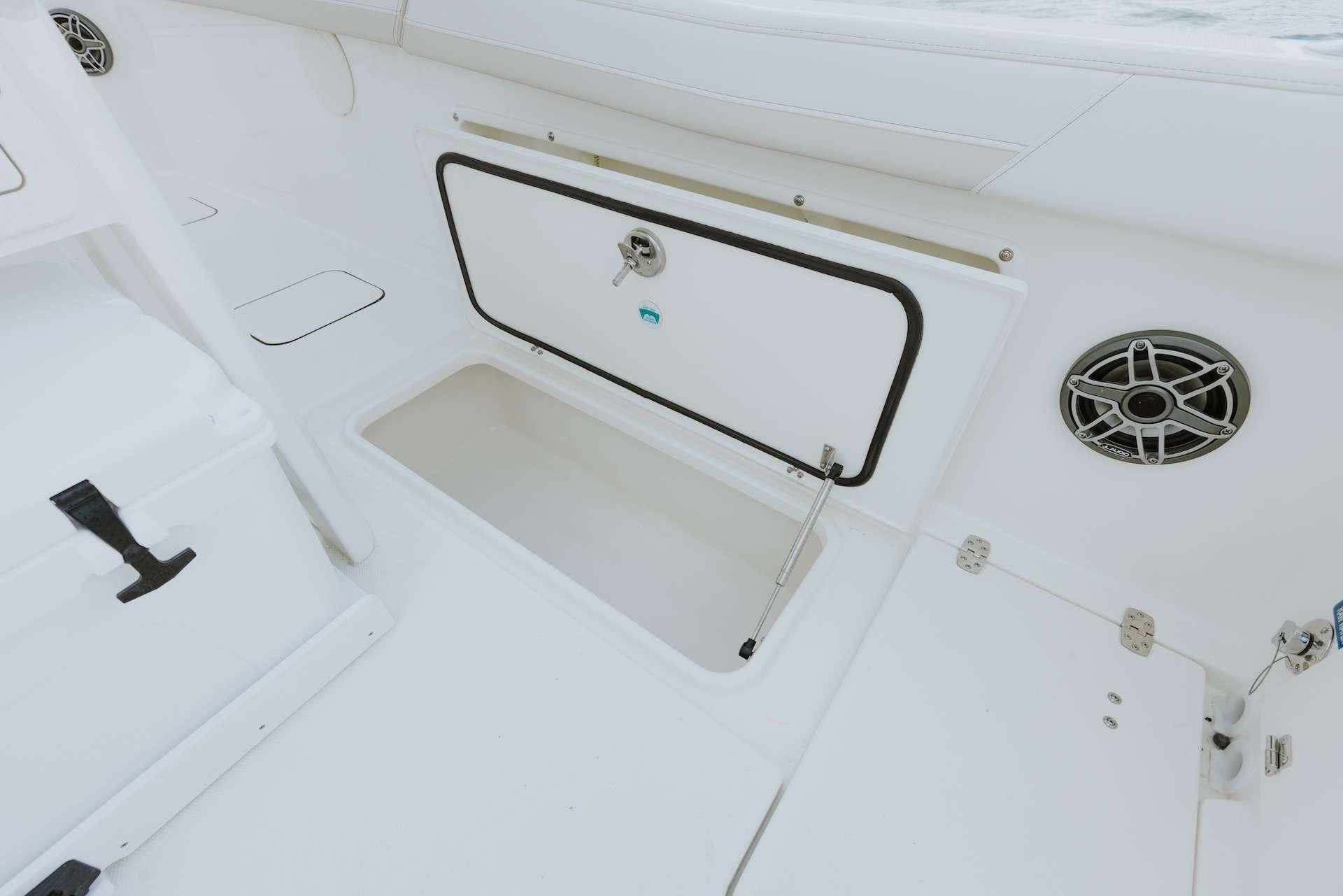 2026 World Cat 235TE boat interior with storage compartment and speaker.